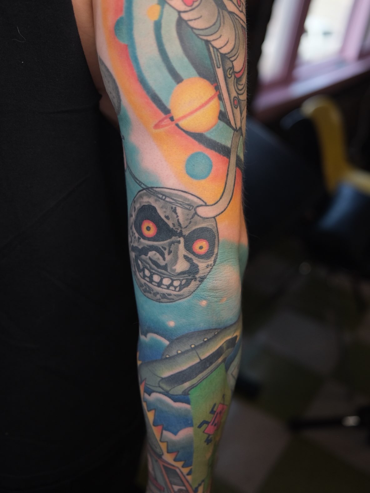 Alien skull American traditional tattoo on the forearm by James Maxwell