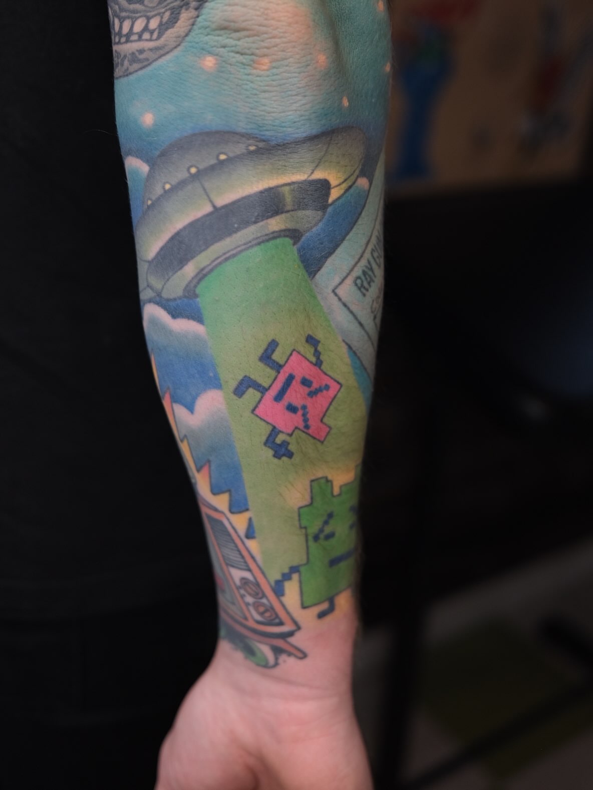 Spacecraft and pixel art dotwork tattoo on the forearm by James Maxwell