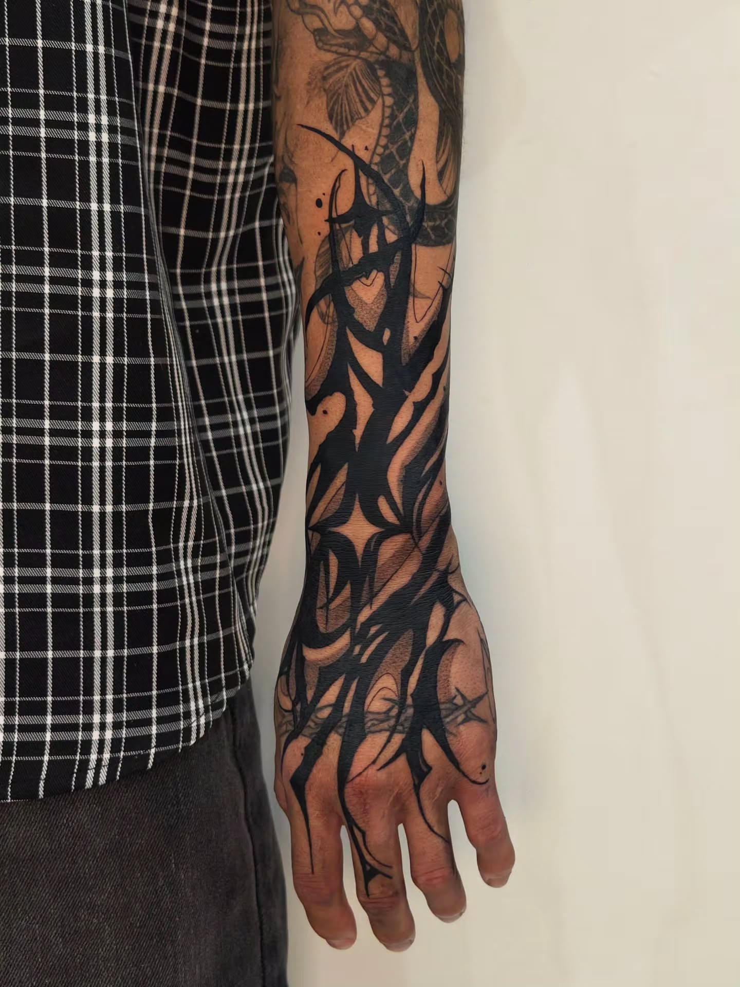 Abstract design black and grey tattoo on the forearm by Jess Dominguez