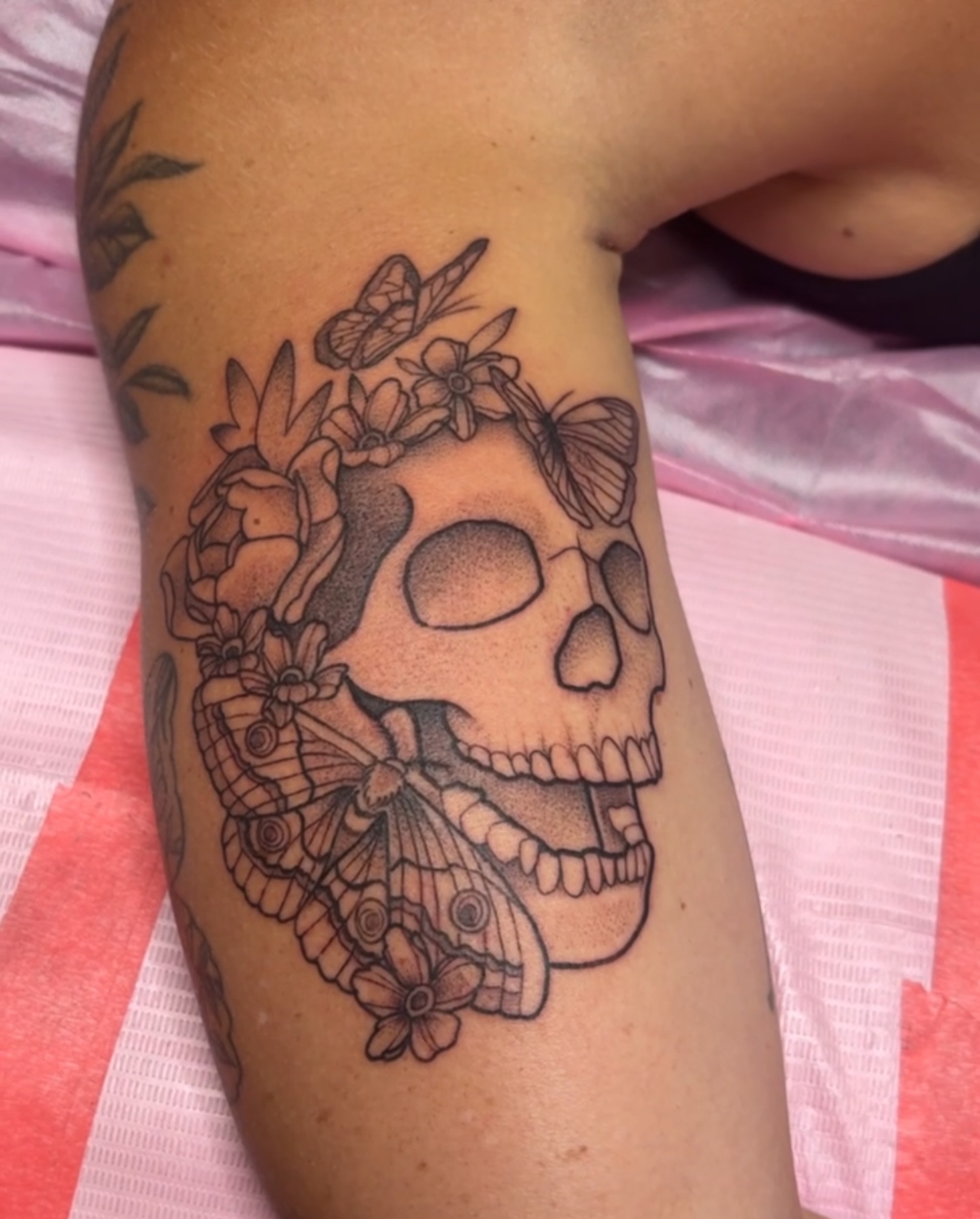 Skull with flowers and butterflies realism tattoo on the forearm by Car🦋🌈 Dallas Tattoo Artist💖