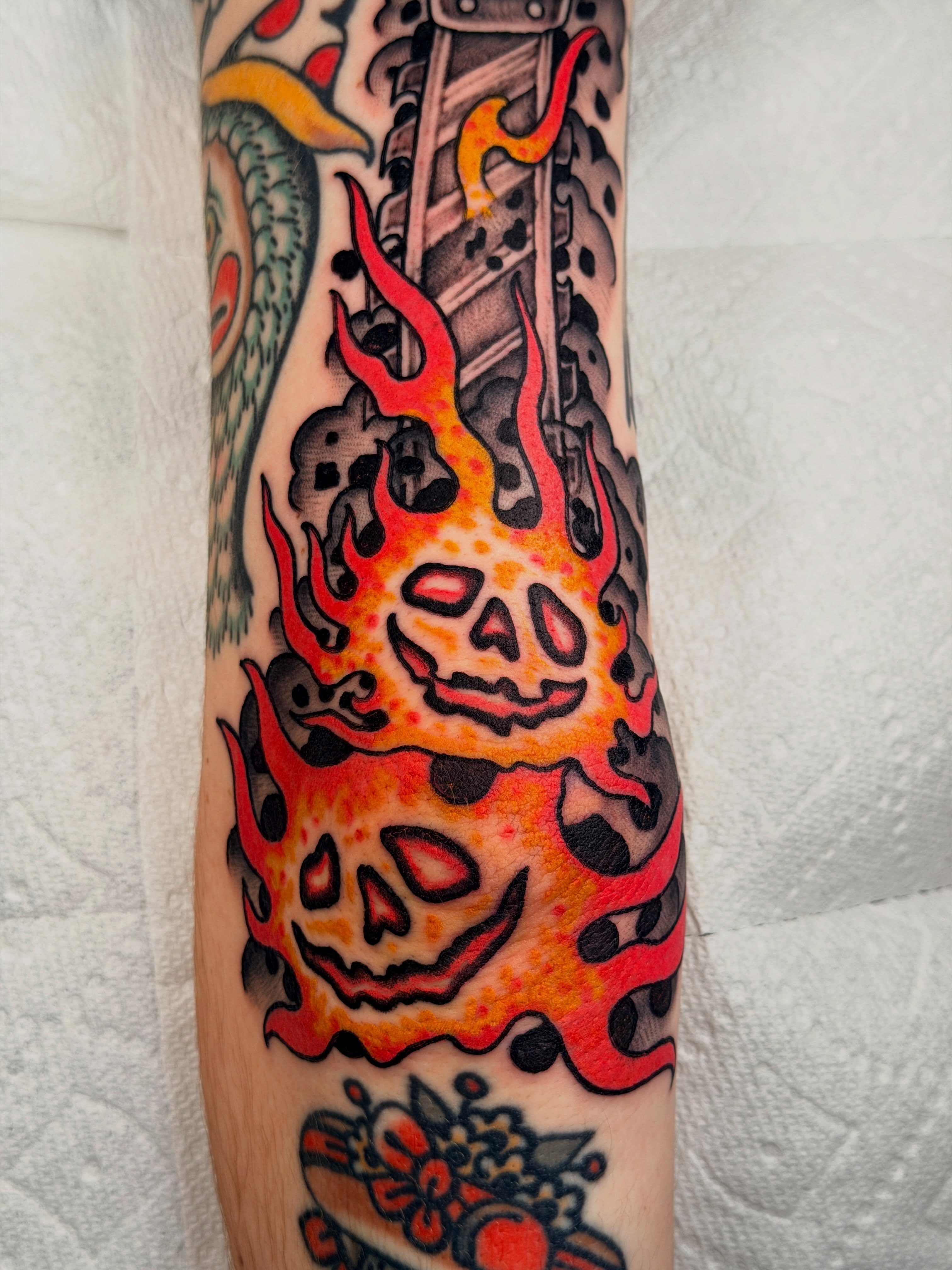 Flaming skulls American traditional tattoo on the forearm by ๐๐ซ๐ข๐ ๐๐ฅ๐ญ๐จ๐ง๐๐ง