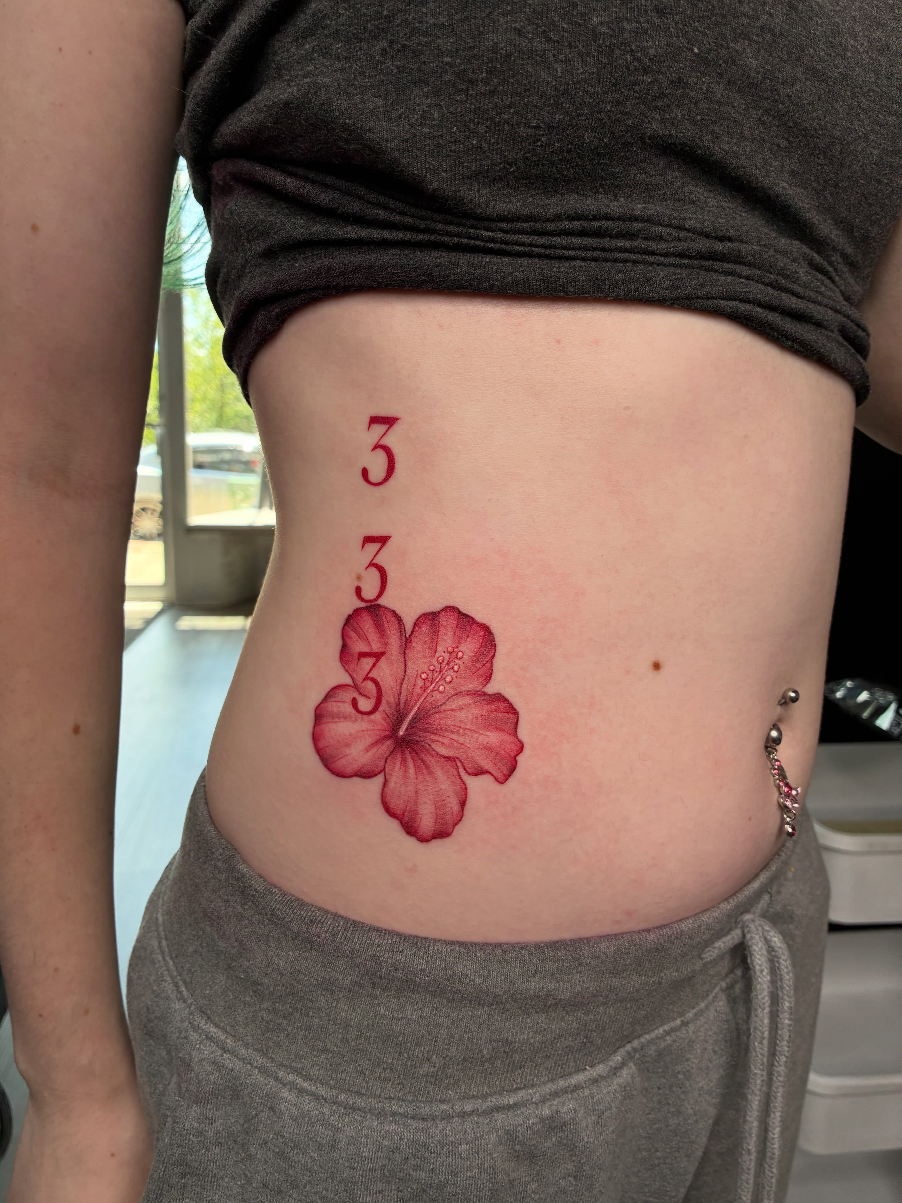 Hibiscus flower realism tattoo on the ribs by Tattoos by Hailey