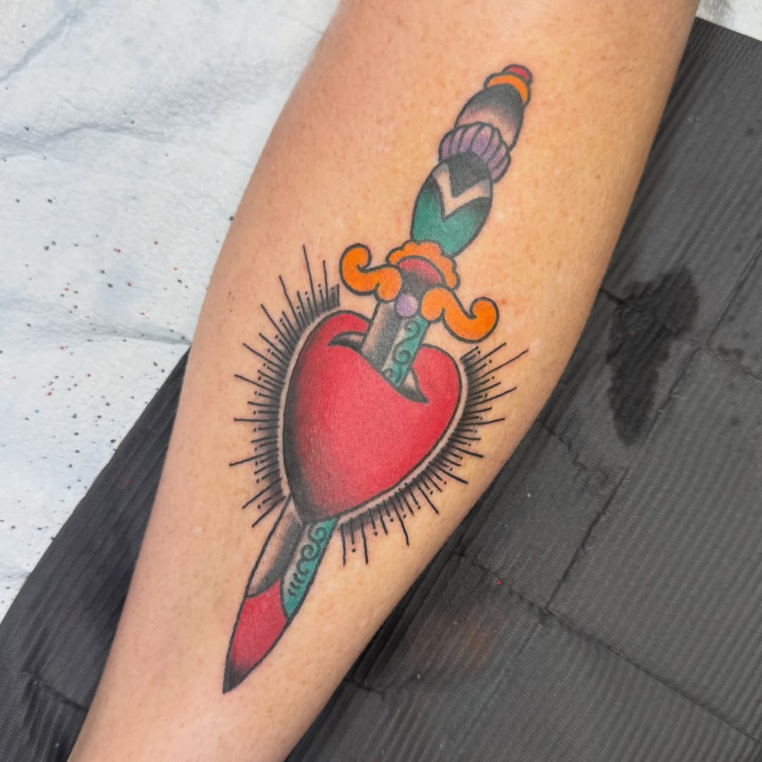 Heart pierced by dagger American traditional tattoo on the forearm by Michael Roehrich (MEECH!)