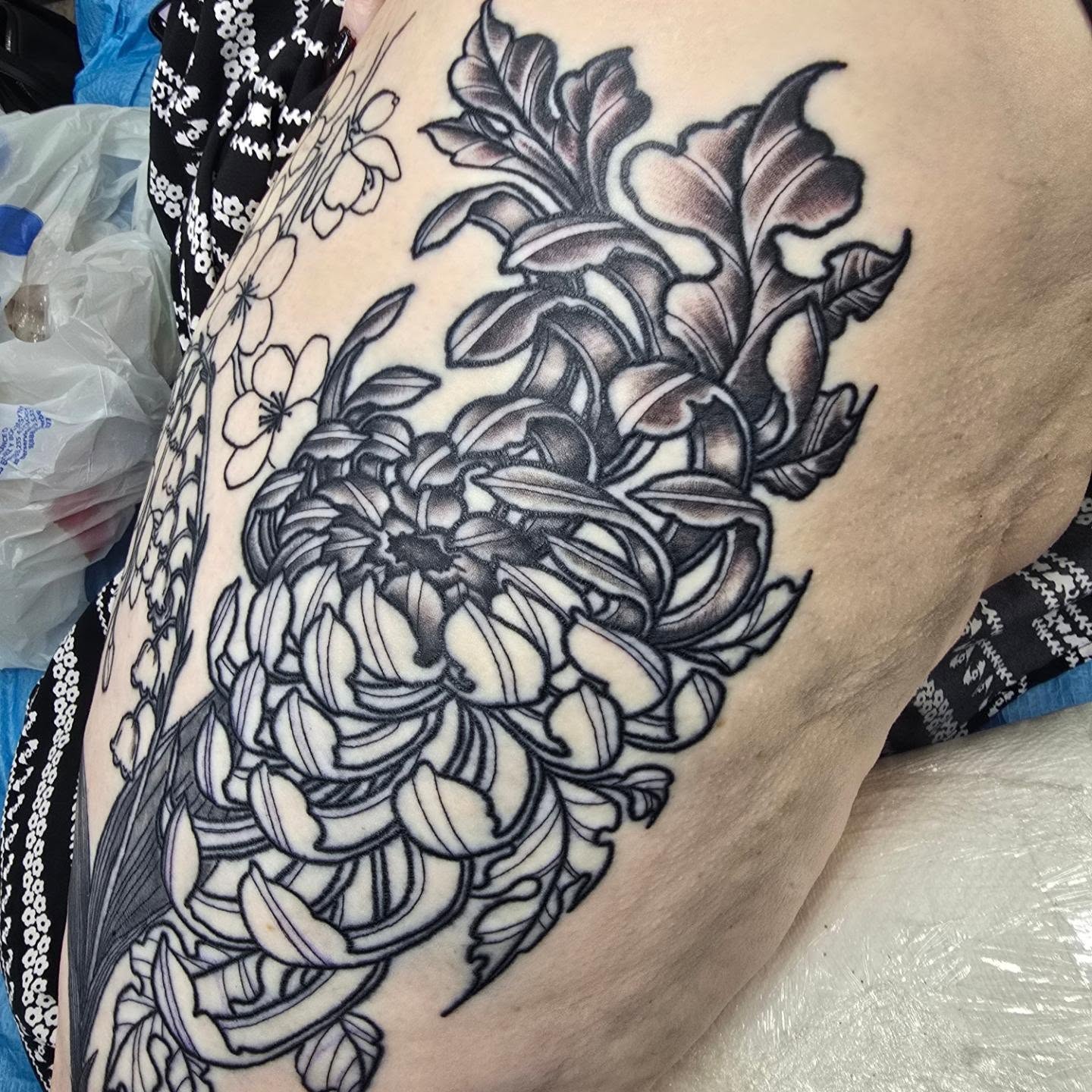 Chrysanthemum black and grey tattoo on the thigh by Captain Michael Devious