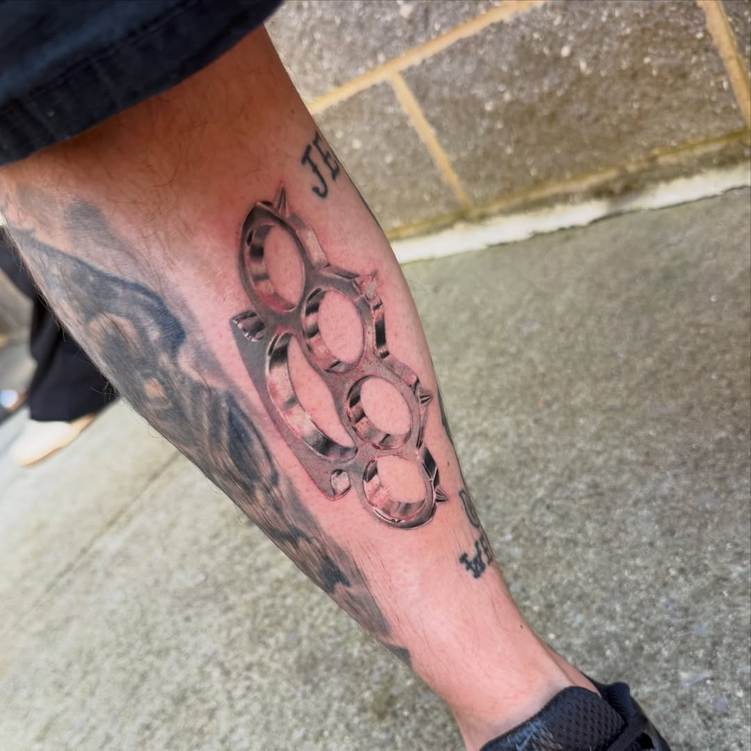 Knuckle dusters black and grey tattoo on the forearm by Rebecca (Becca) Ray