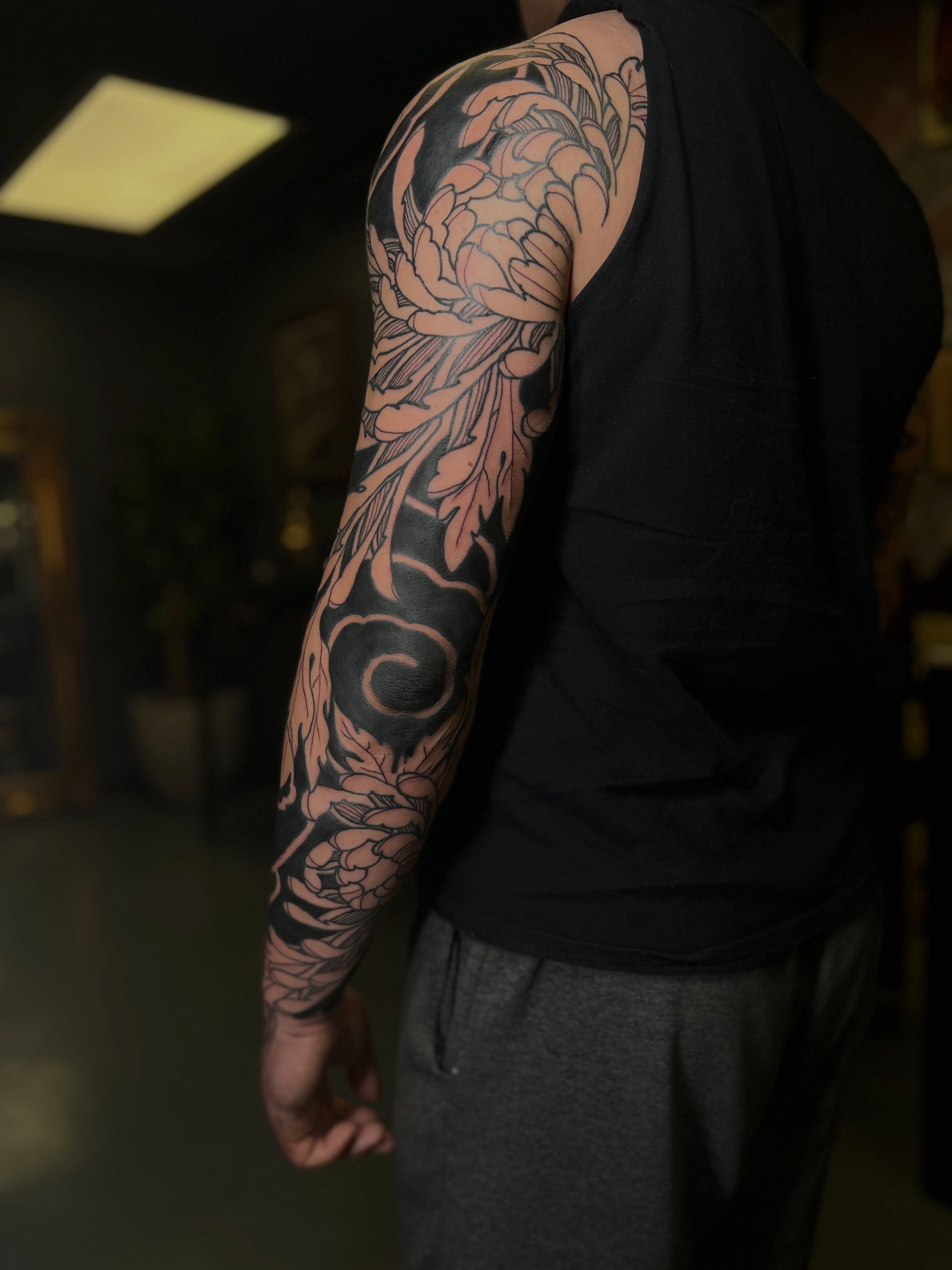 Floral design japanese irezumi tattoo on the upper arm by Kaichi Fujita, Eugene, Oregon