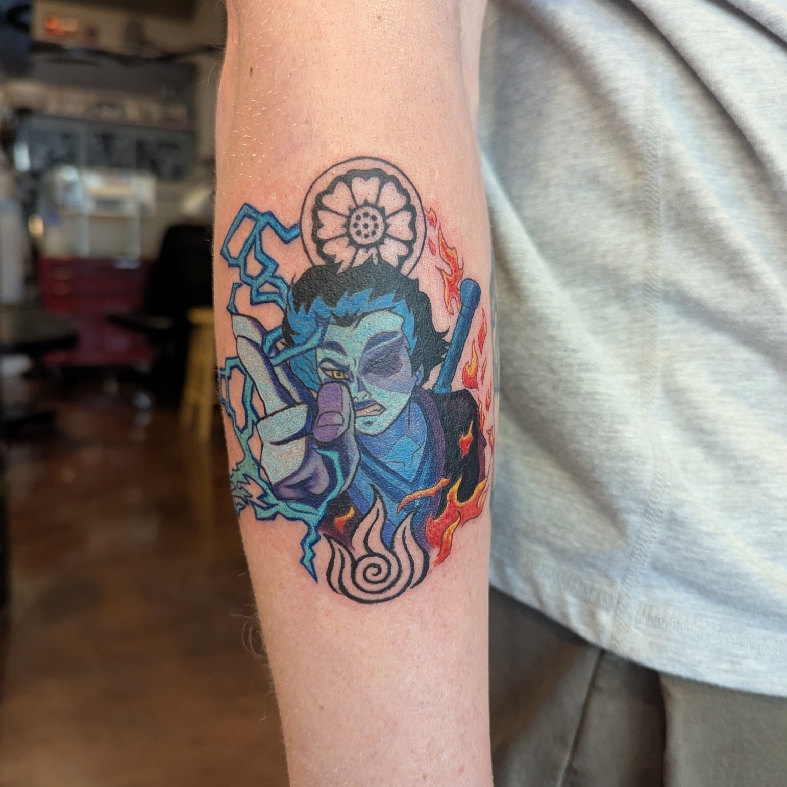 Deity with flames geometric tattoo on the forearm by Raven FM-Tattoo Apprentice
