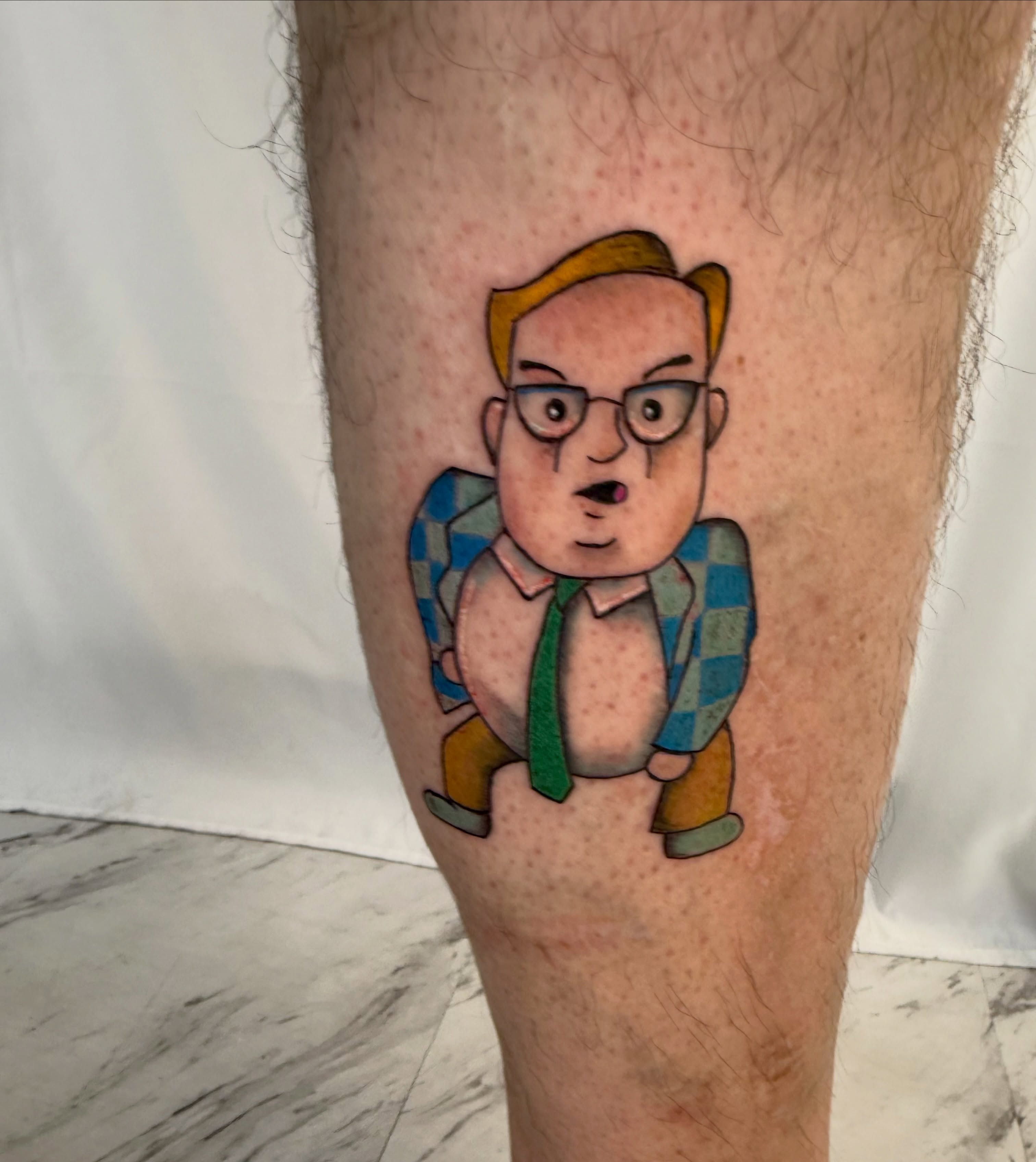 Cartoon character illustrative tattoo on the leg by Jerry Thomas