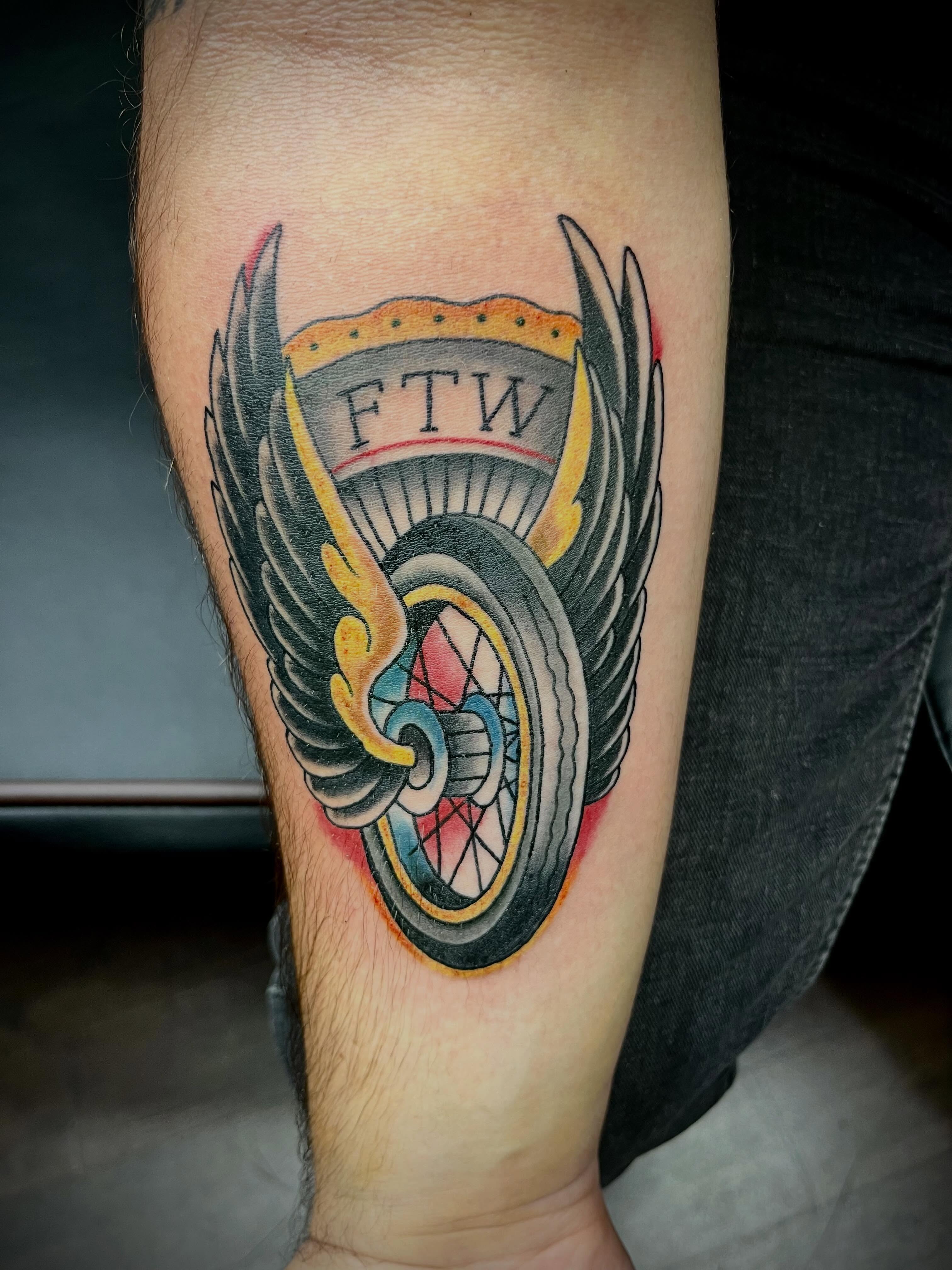 Wings and shield American traditional tattoo on the forearm by Kenny Buck