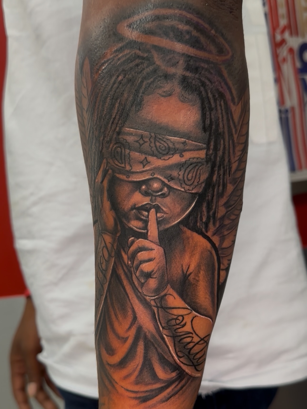 Blindfolded angel realism tattoo on the forearm by guinn_art_tatts, Le Moule
