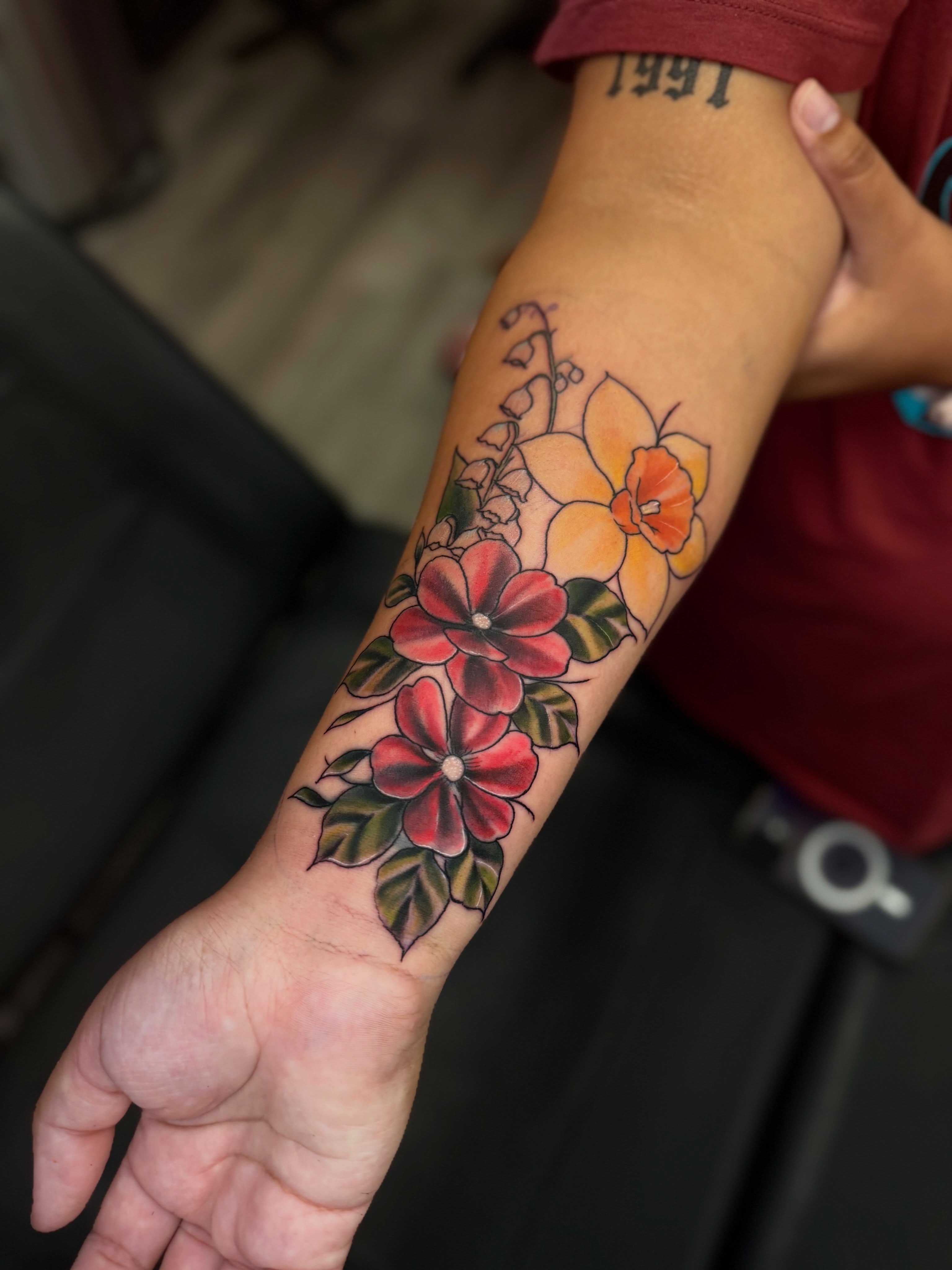 Floral arrangement American traditional tattoo on the forearm by Ray De Leon