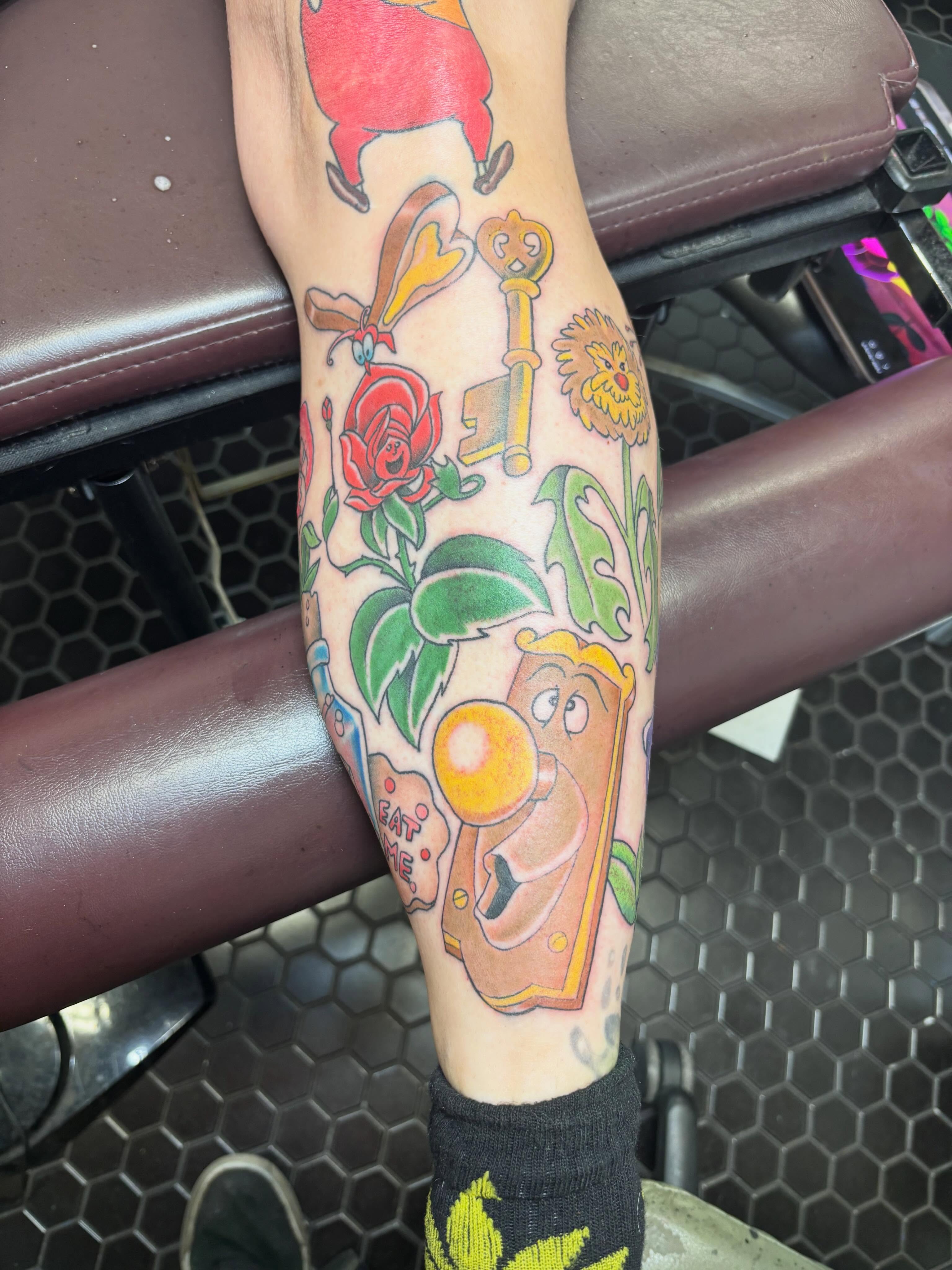 Cartoon character with flowers new school tattoo on the forearm by Scottbarrytattoos@gmail.com