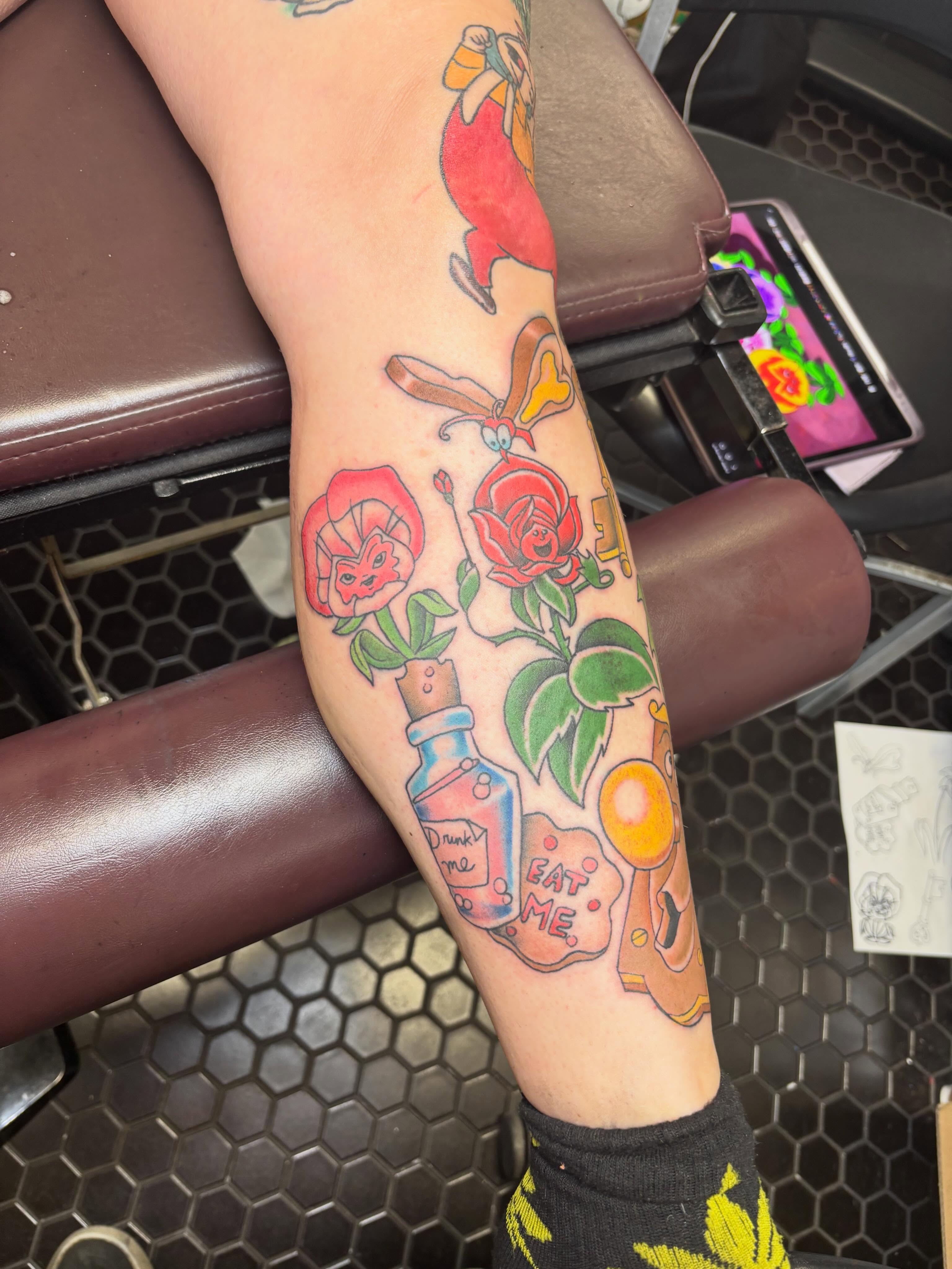 Rose and potion bottle American traditional tattoo on the forearm by Scottbarrytattoos@gmail.com