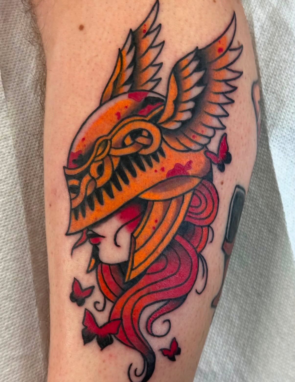 Woman with dragon helmet American traditional tattoo on the forearm by Samuel Dickey