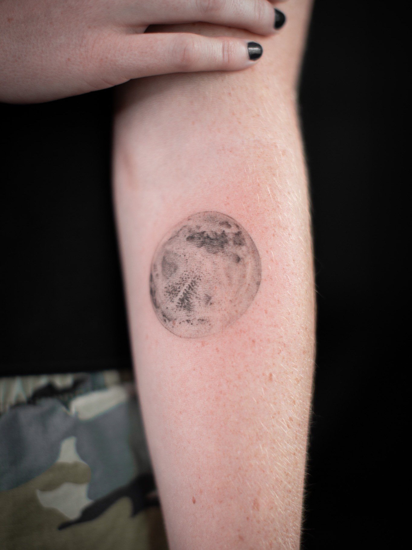 Moon black and grey tattoo on the forearm by Aries Rising