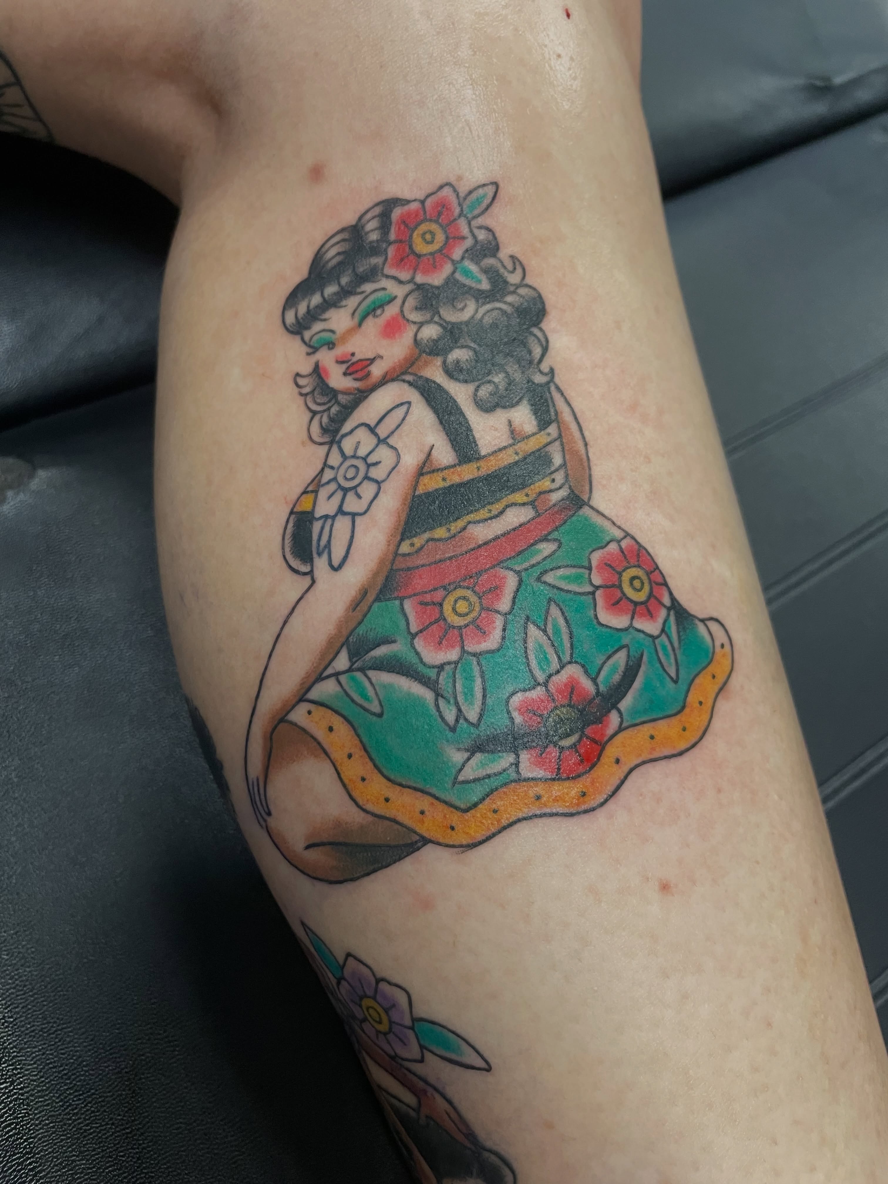 Woman in floral dress American traditional tattoo on the thigh by Steven Hodges