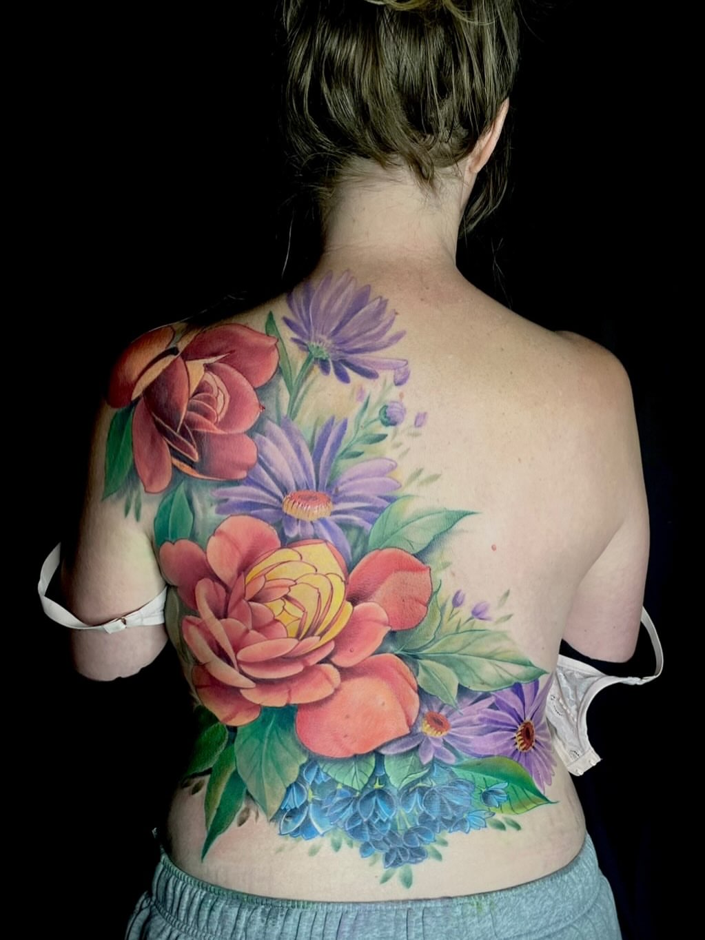 Floral bouquet realism tattoo on the back by jonhighland
