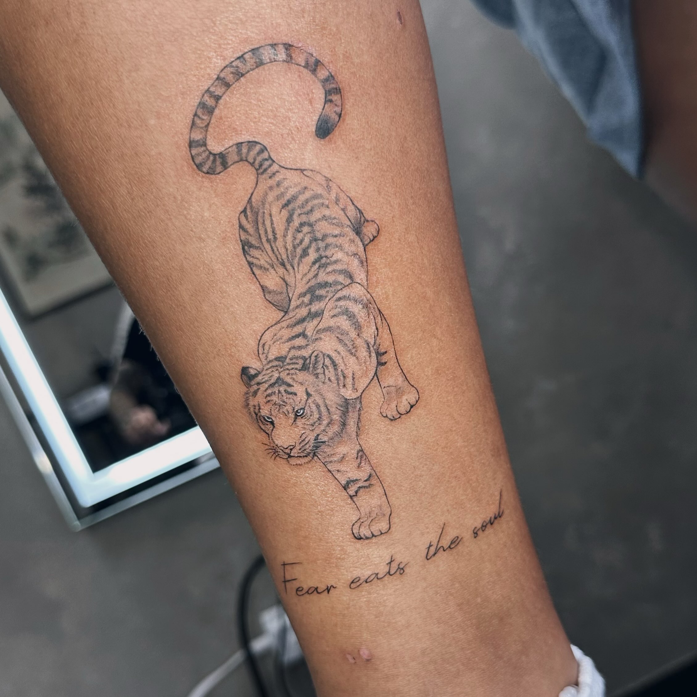 Tiger black and grey tattoo on the forearm by Liv