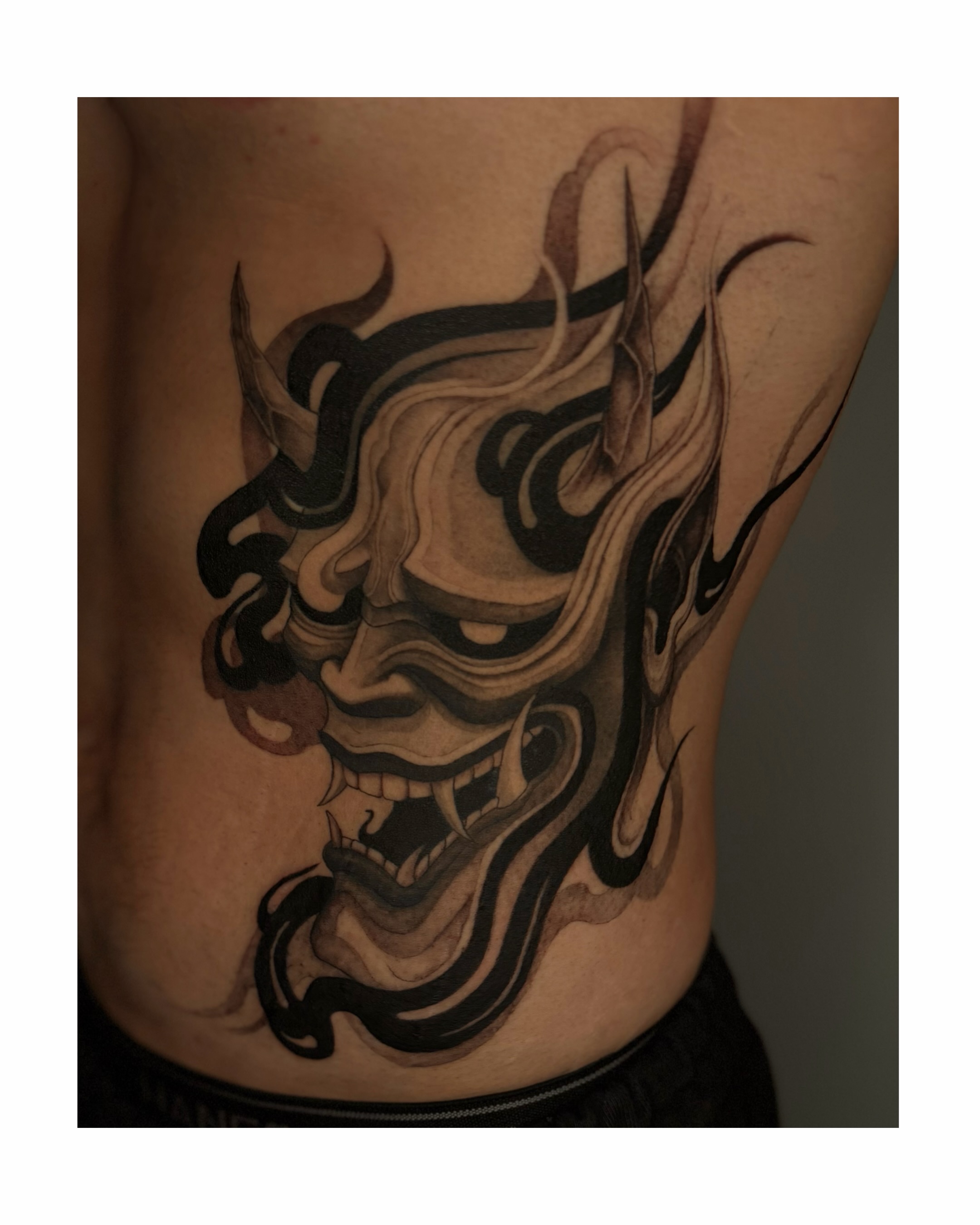 Demon mask japanese irezumi tattoo on the ribs by Sab