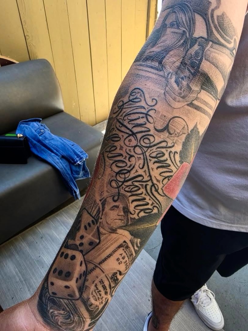 Astronaut and dice realism tattoo on the forearm by San Diego Tattoo Artist