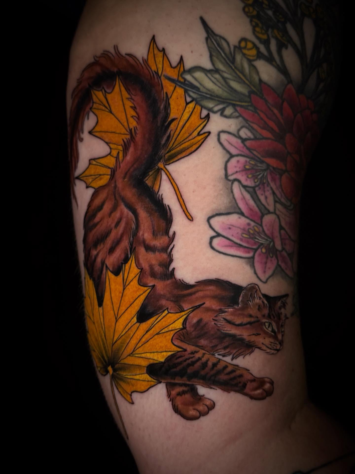 Cat and autumn leaves realism tattoo on the upper arm by Jacie Aasen-Lupino