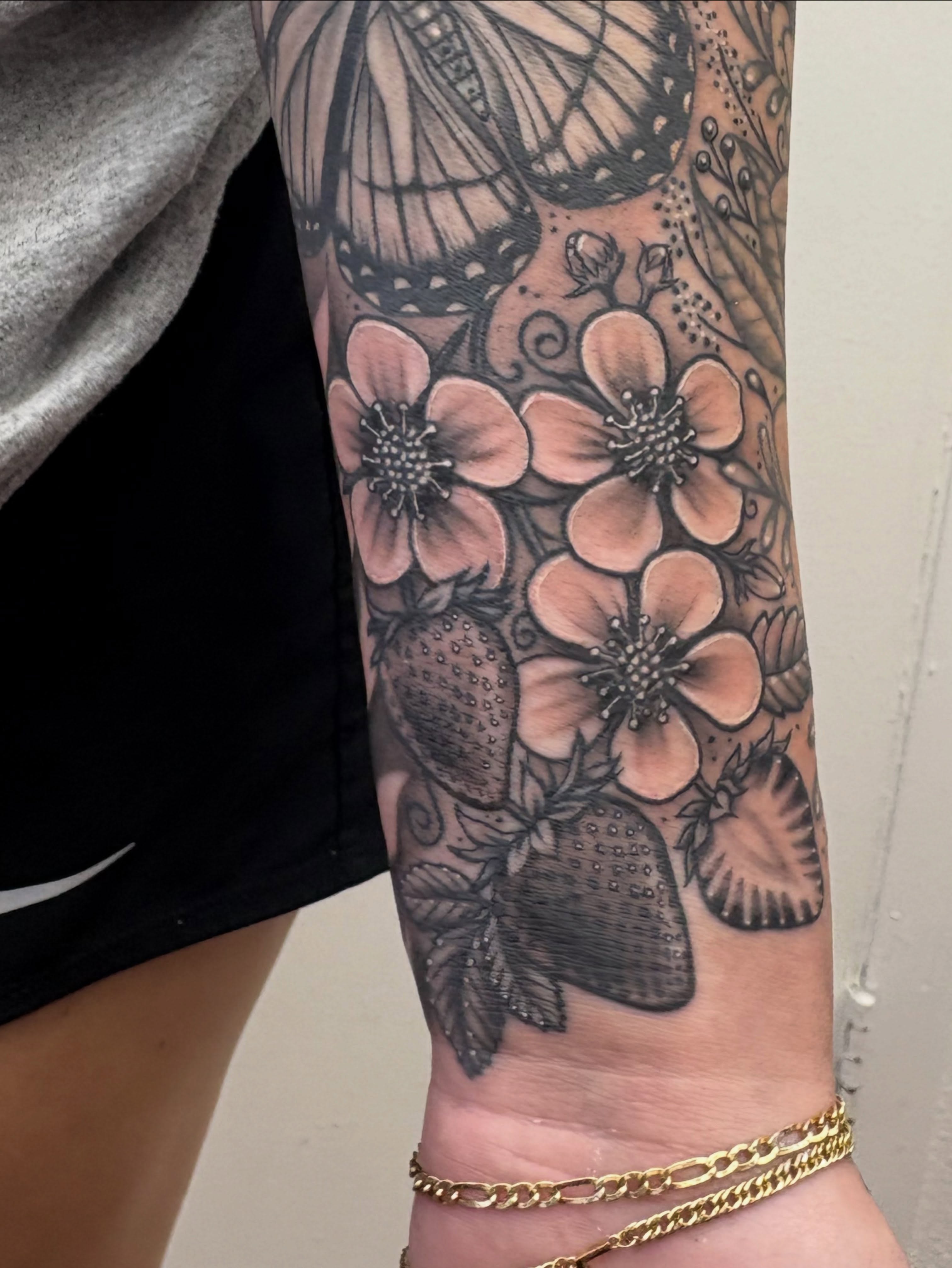 Flowers and butterflies dotwork tattoo on the forearm by Skye California