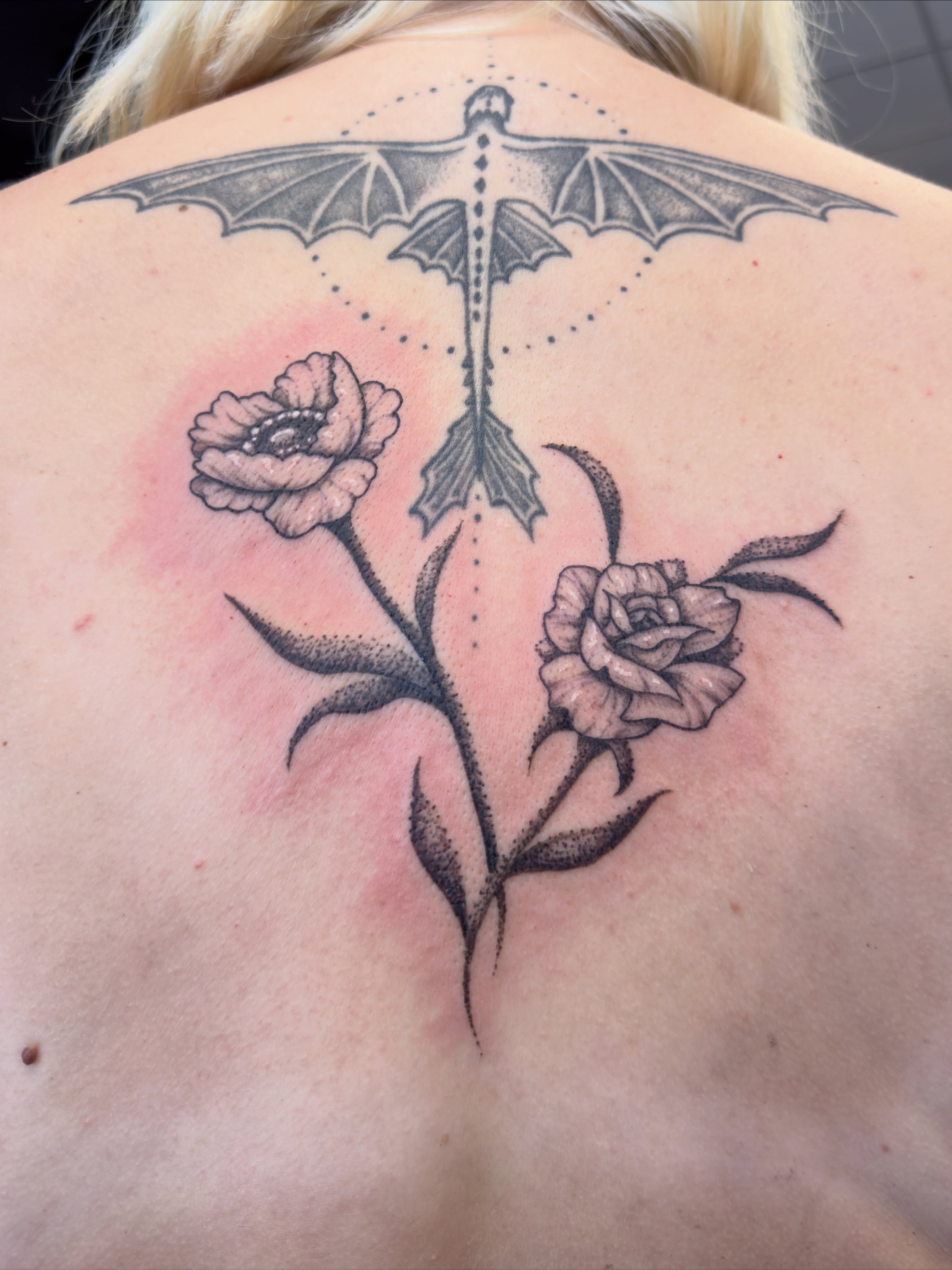 Bat and flowers dotwork tattoo on the back by Diana