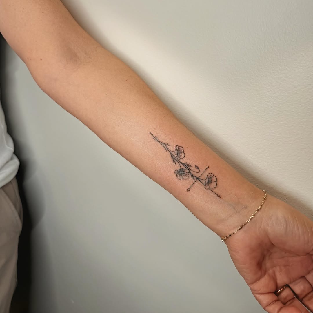 Flowers fine line tattoo on the forearm by Ashlee Burkey