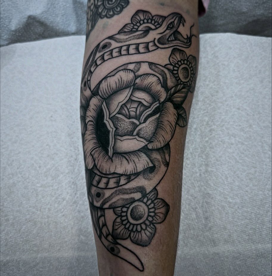 Snake and rose American traditional tattoo on the forearm by Tanya Gomez