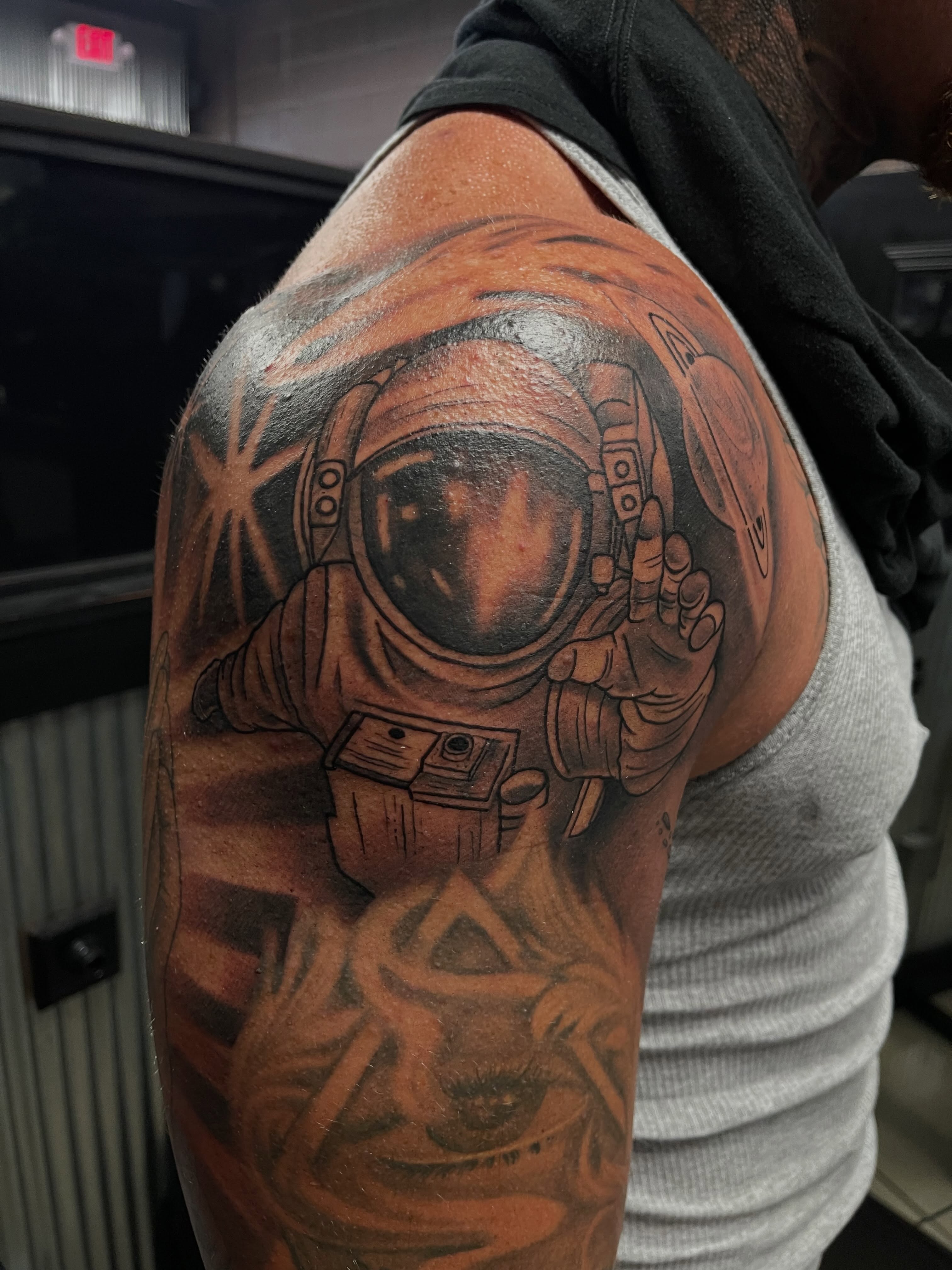 Astronaut realism tattoo on the shoulder by Chris Torres