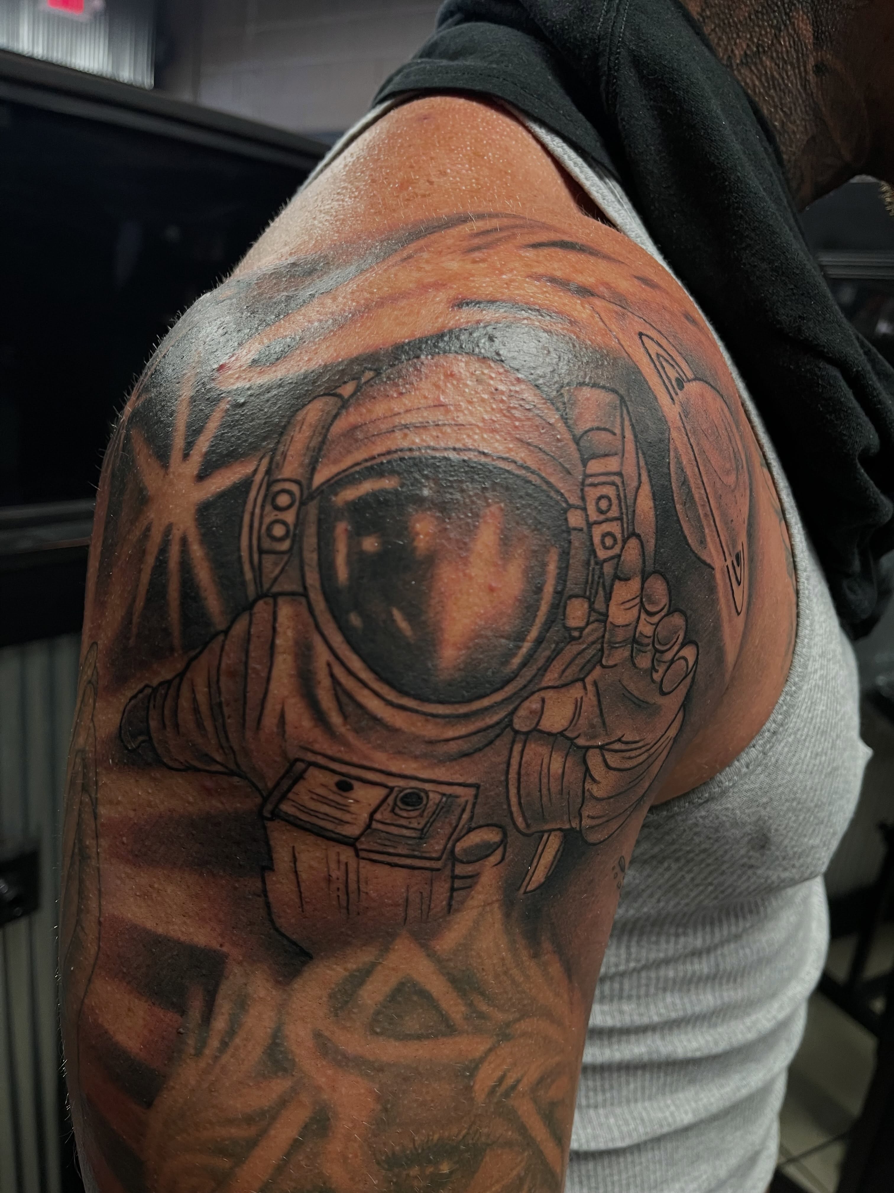 Astronaut realism tattoo on the shoulder by Chris Torres