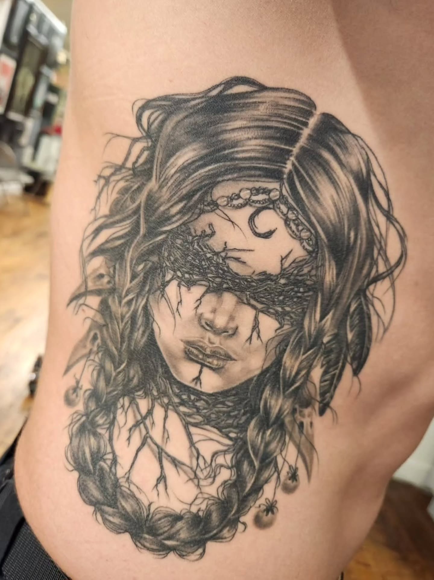 Woman with braids realism tattoo on the thigh by Heather