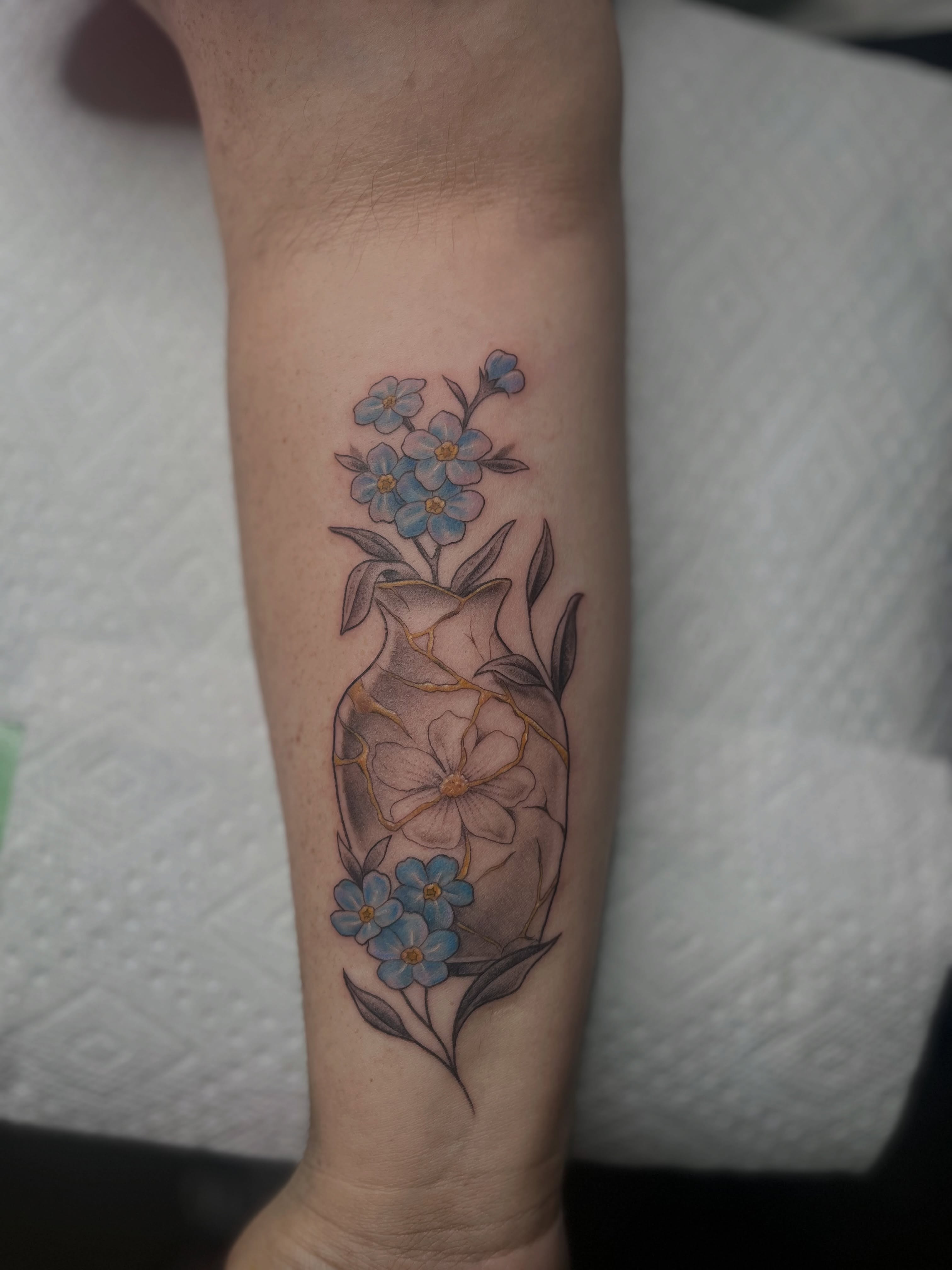 Flower arrangement realism tattoo on the forearm by Lexi Ross