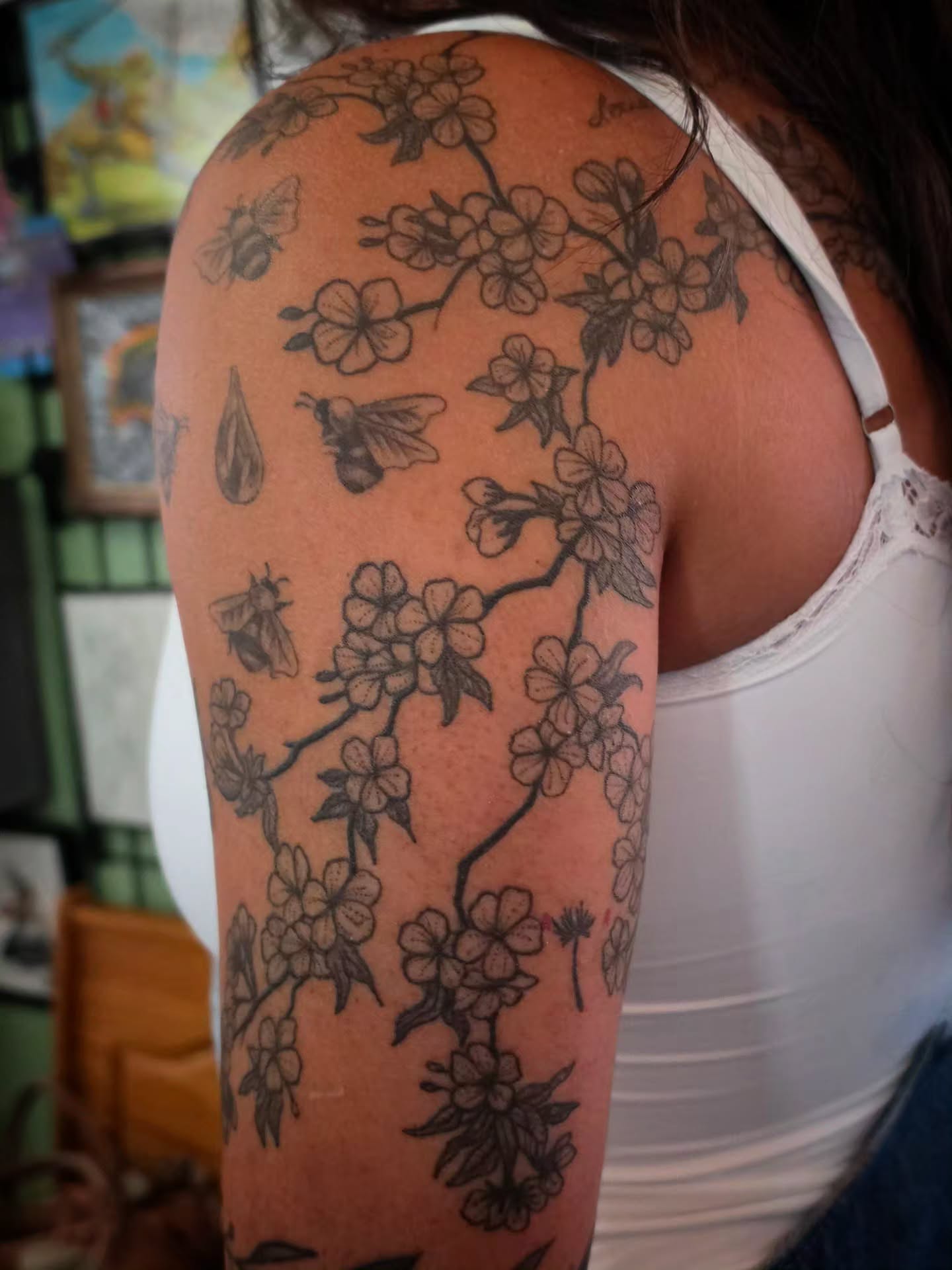 Cherry blossoms and bees black and grey tattoo on the upper arm by brockton a f 💀