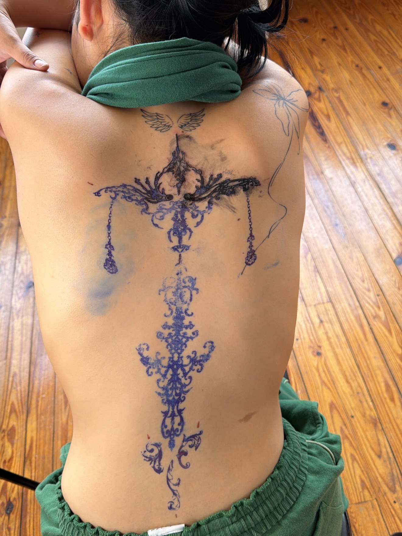 Chandelier ornamental tattoo on the back by Jose Javier