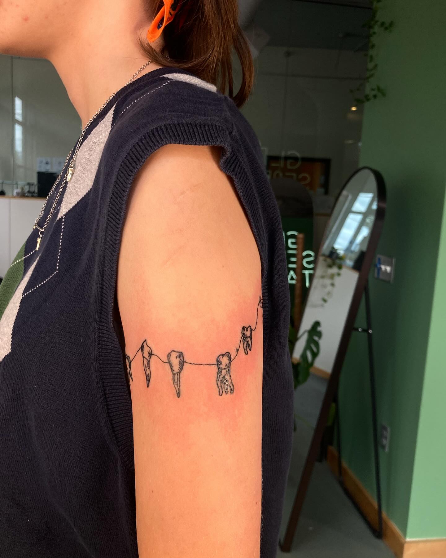 String with teeth minimalist tattoo on the forearm by james <3