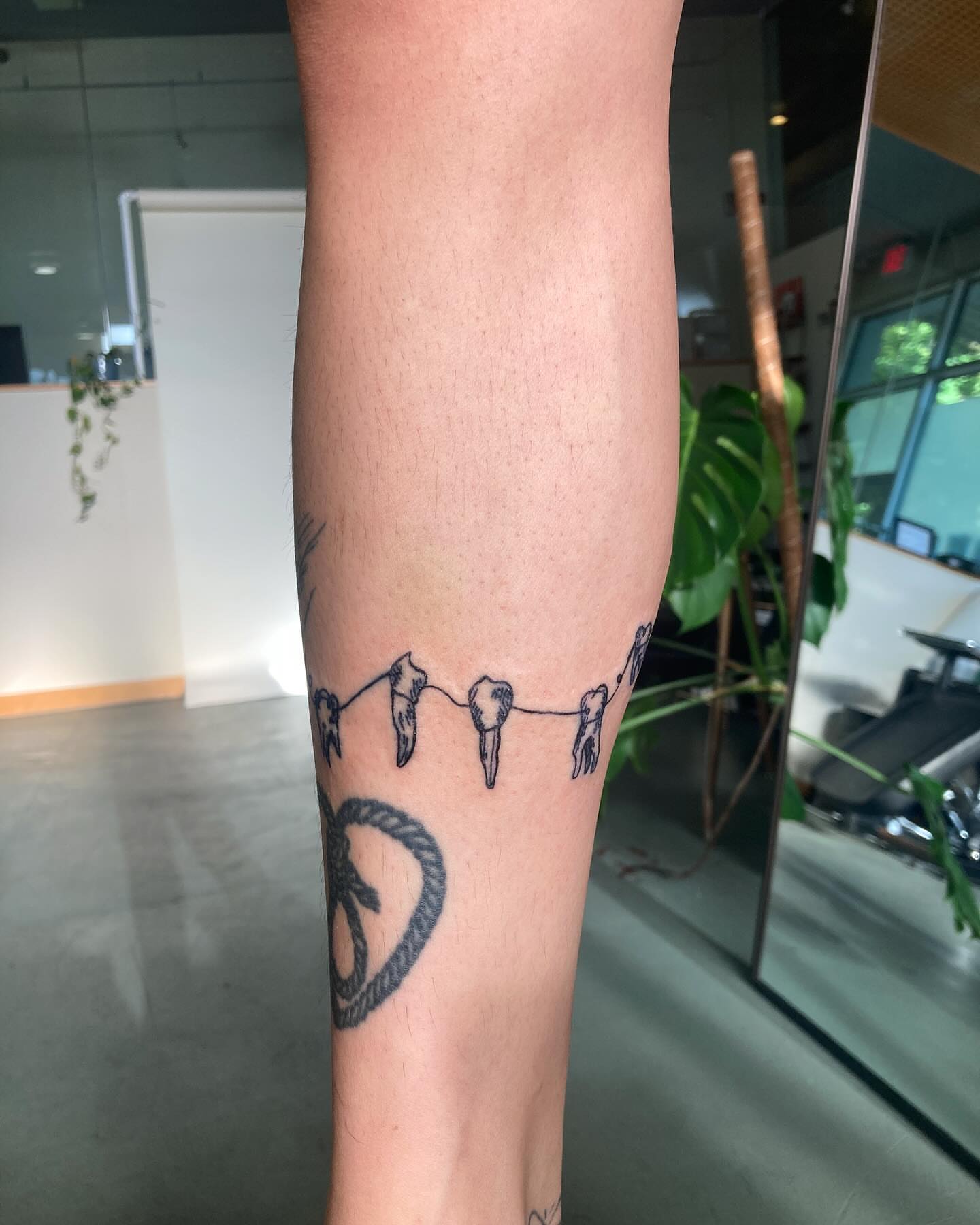 String with teeth black and grey tattoo on the forearm by james <3