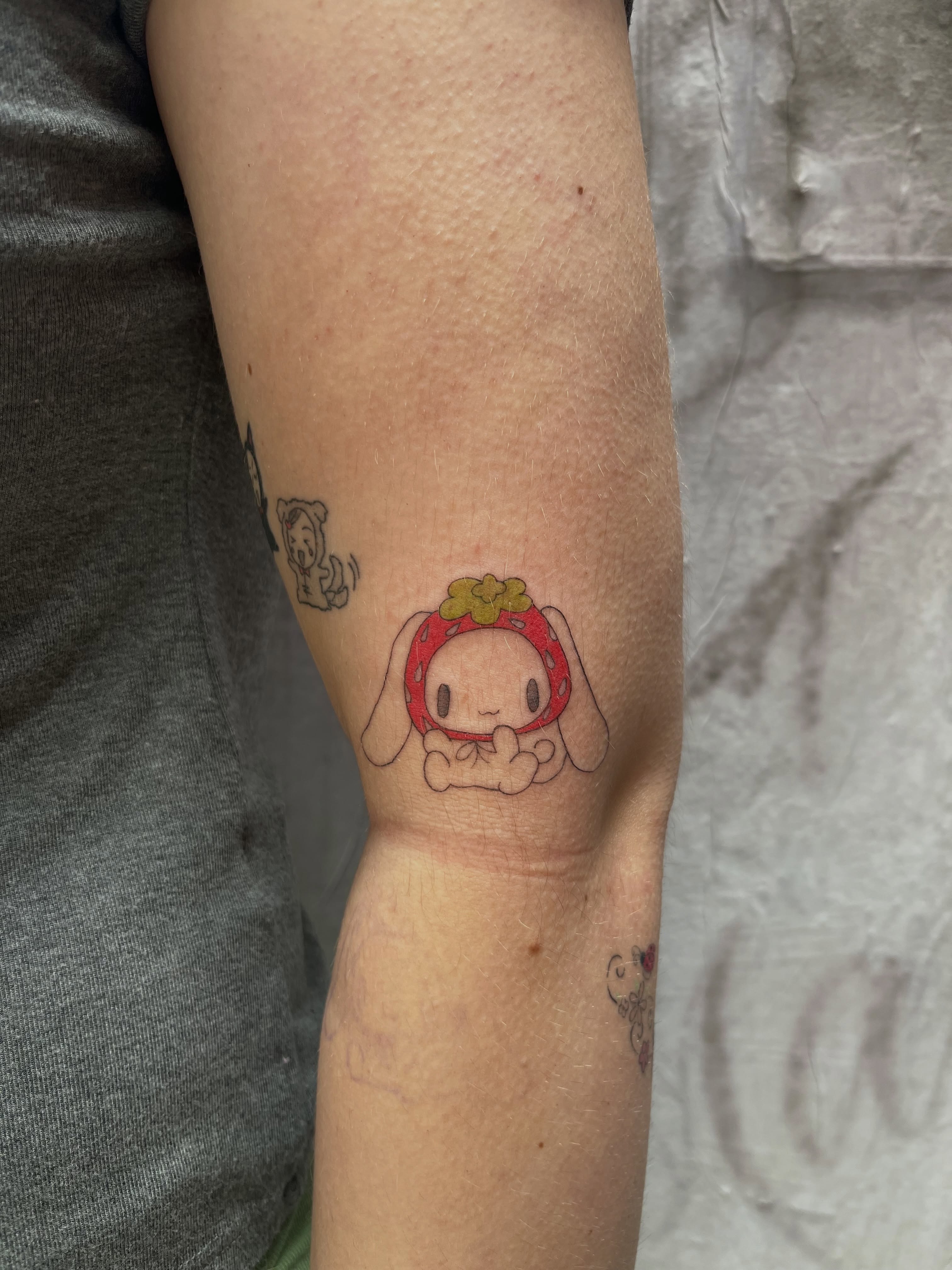 Strawberry bunny dotwork tattoo on the forearm by Kyra Monterrosa