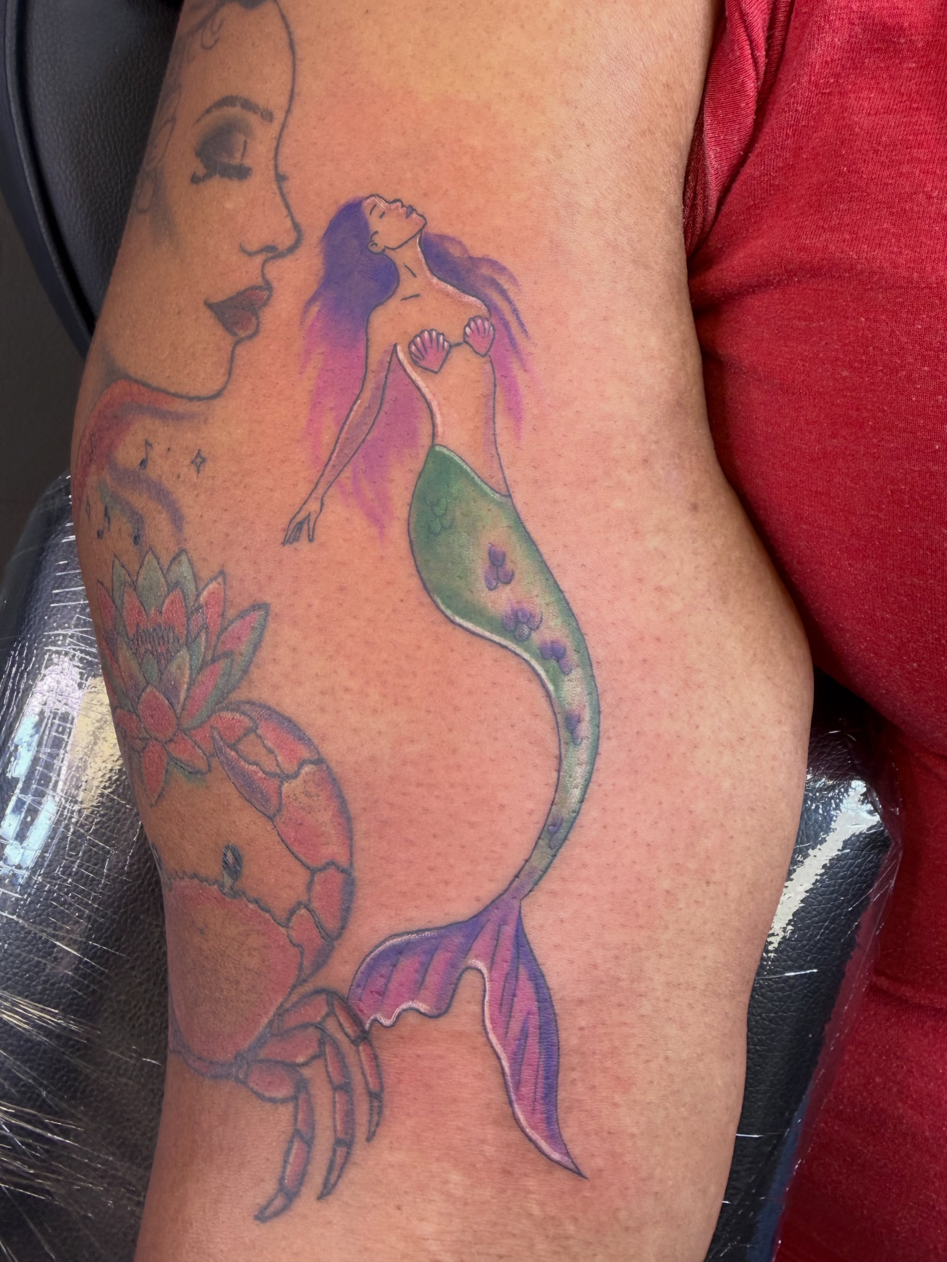 Mermaid and crab watercolor tattoo on the forearm by Rain David