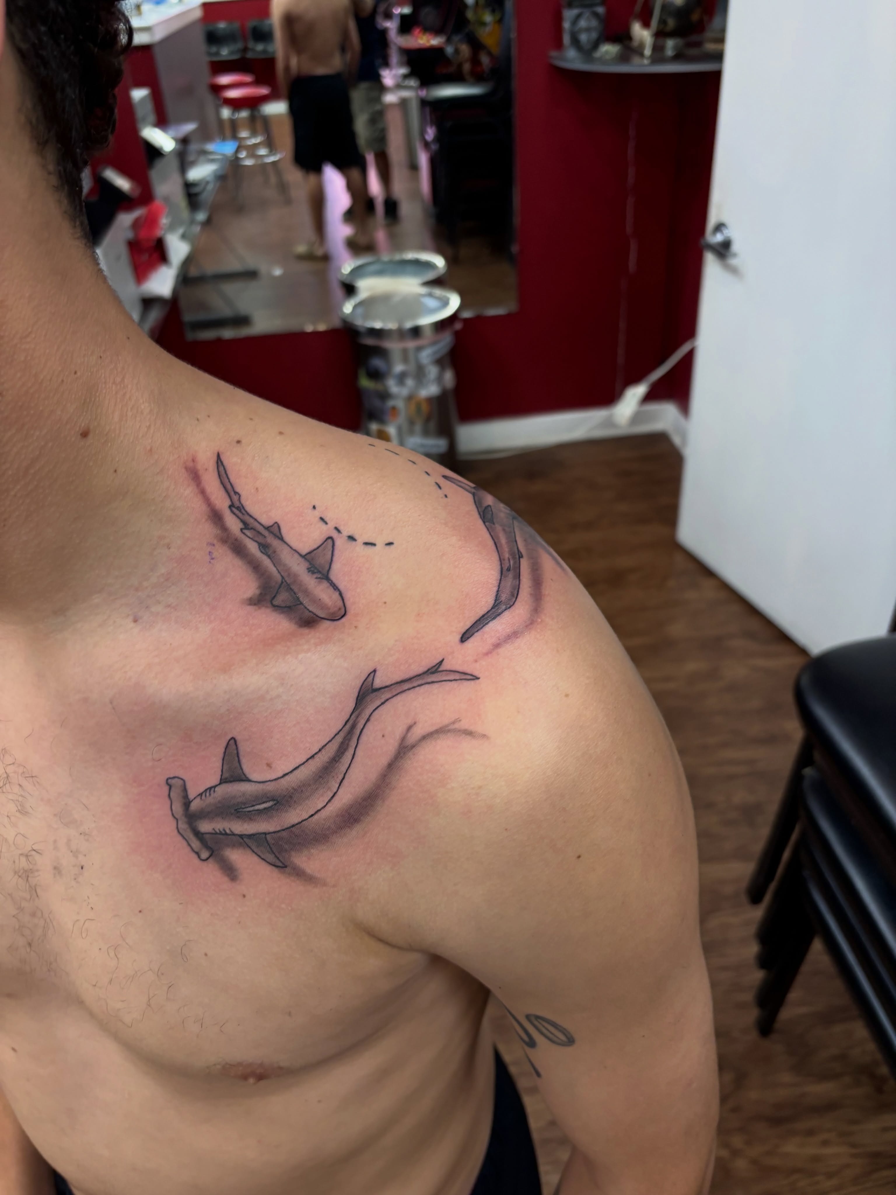 Sharks realism tattoo on the shoulder by Thom Johns-Green