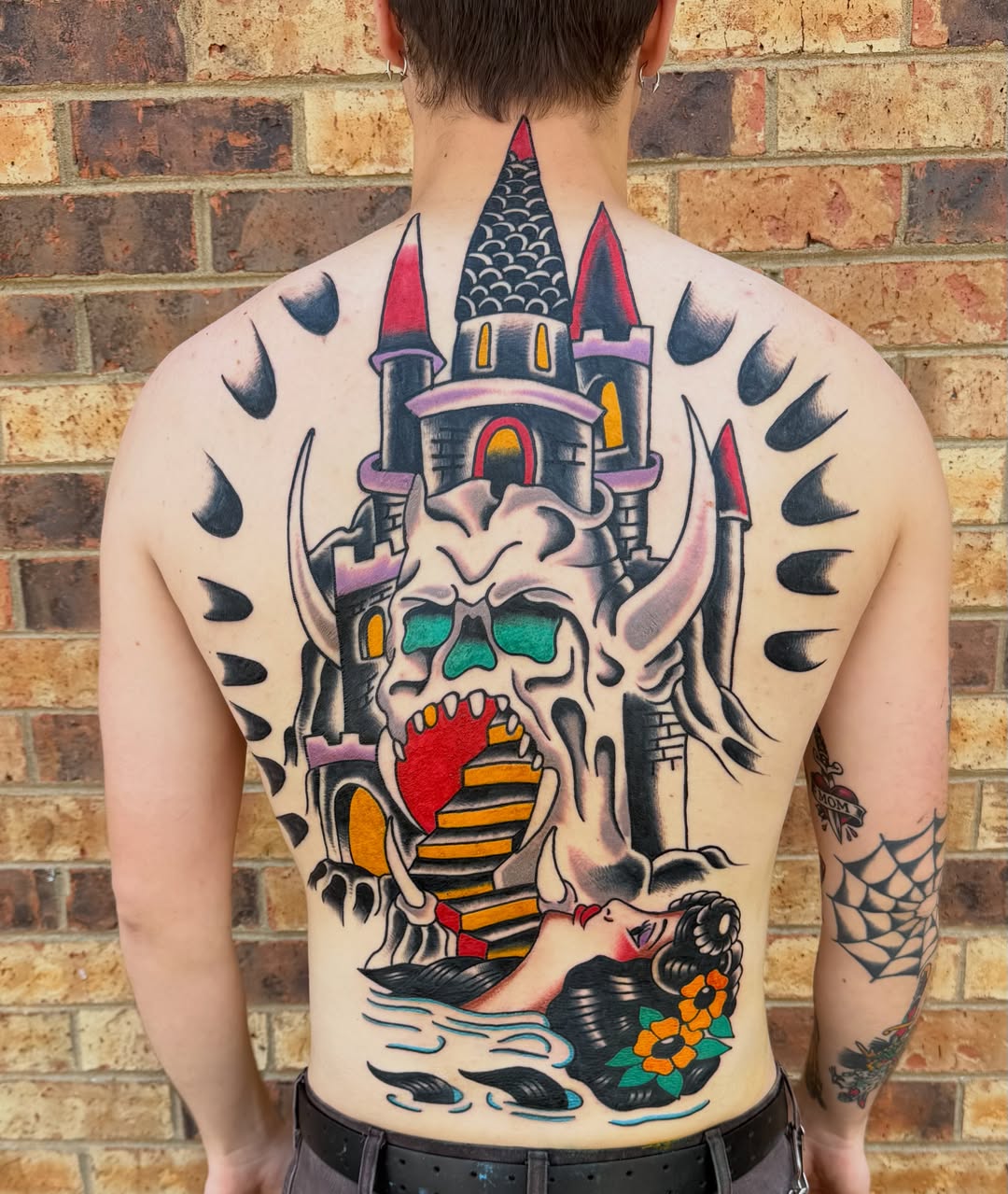 Castle and skull American traditional tattoo on the back by Don Lee