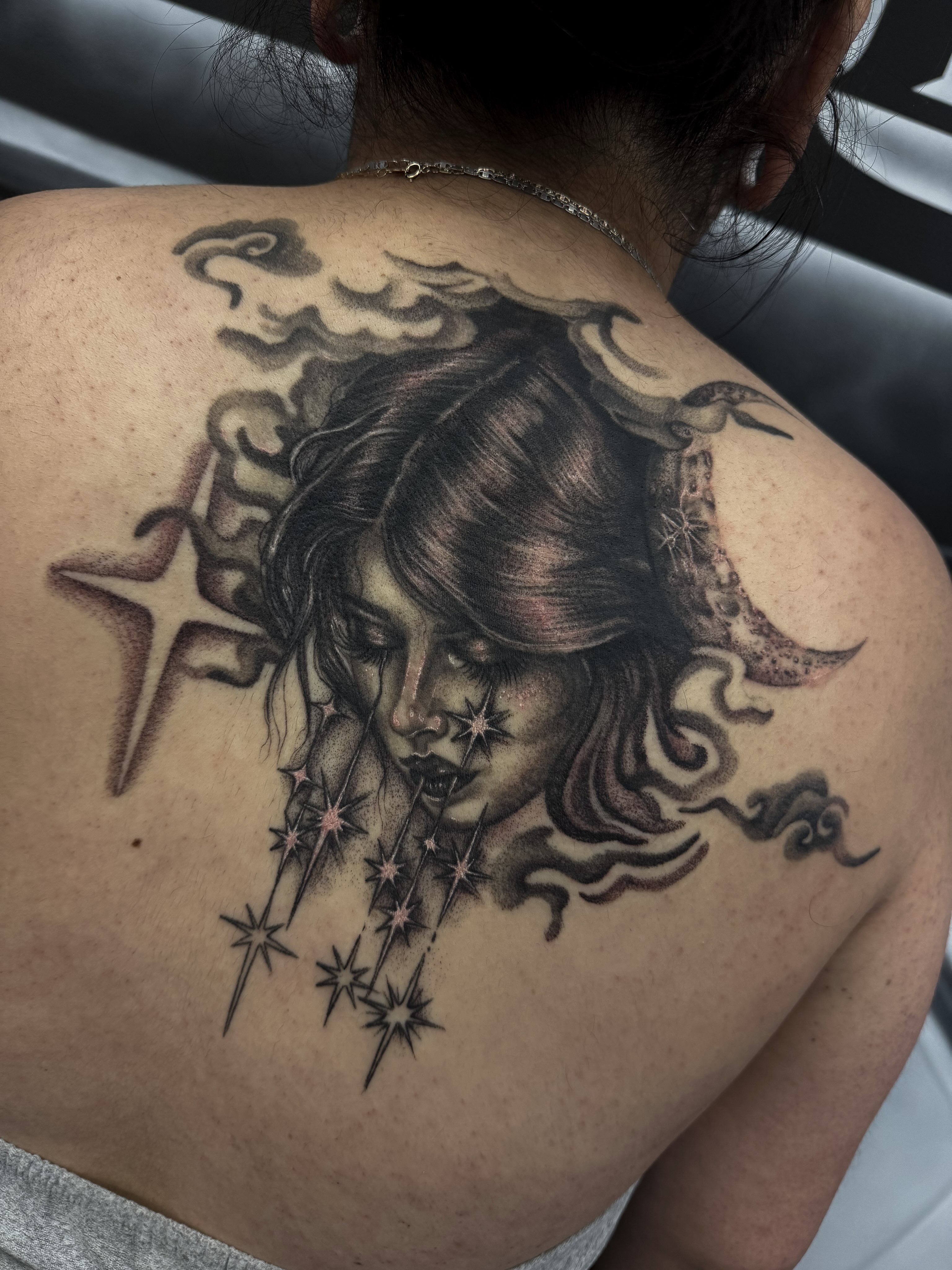 Woman with stars realism tattoo on the back by Yvonne