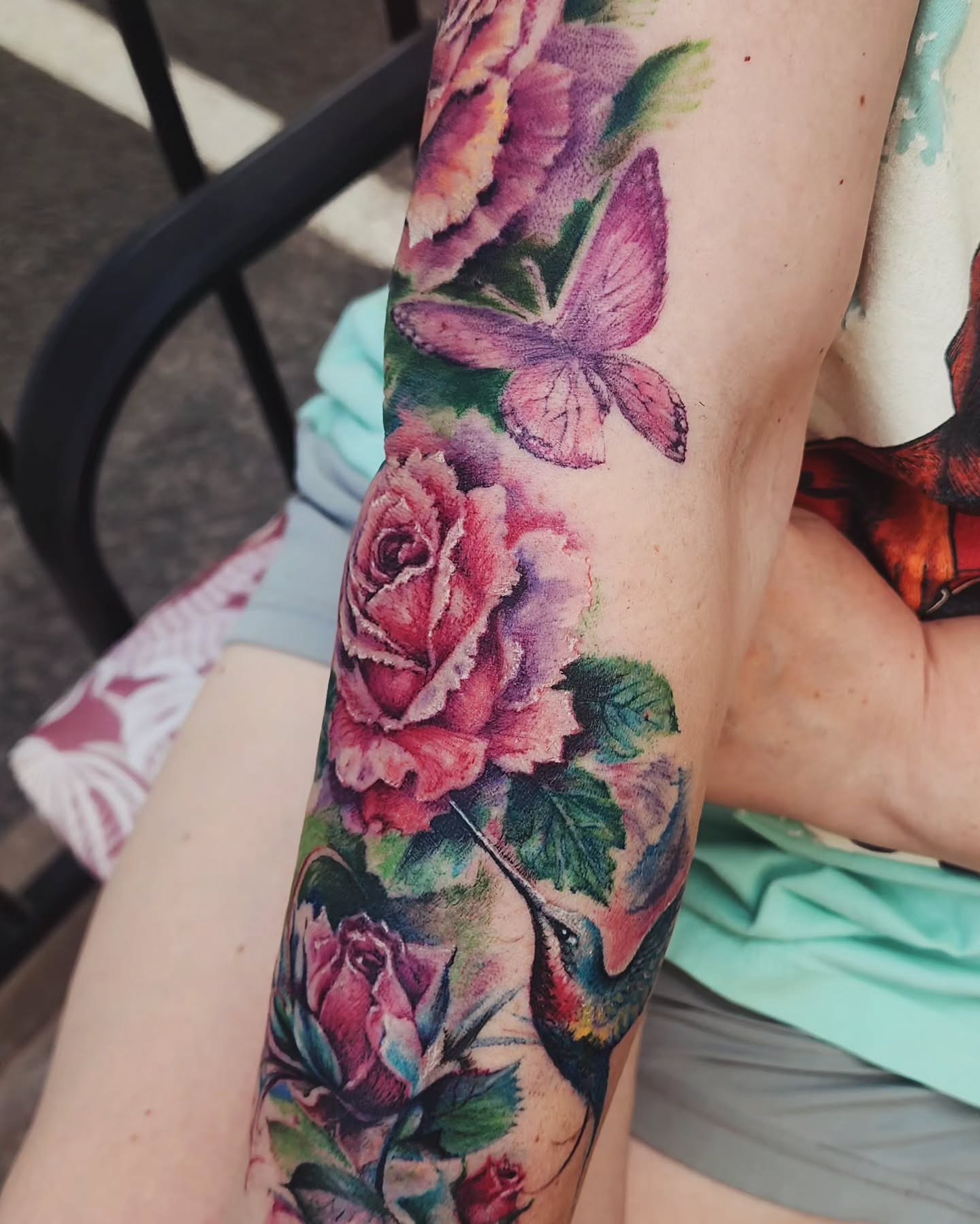 Flower and butterfly watercolor tattoo on the forearm by Dr. Valerio Vegas Tattoo