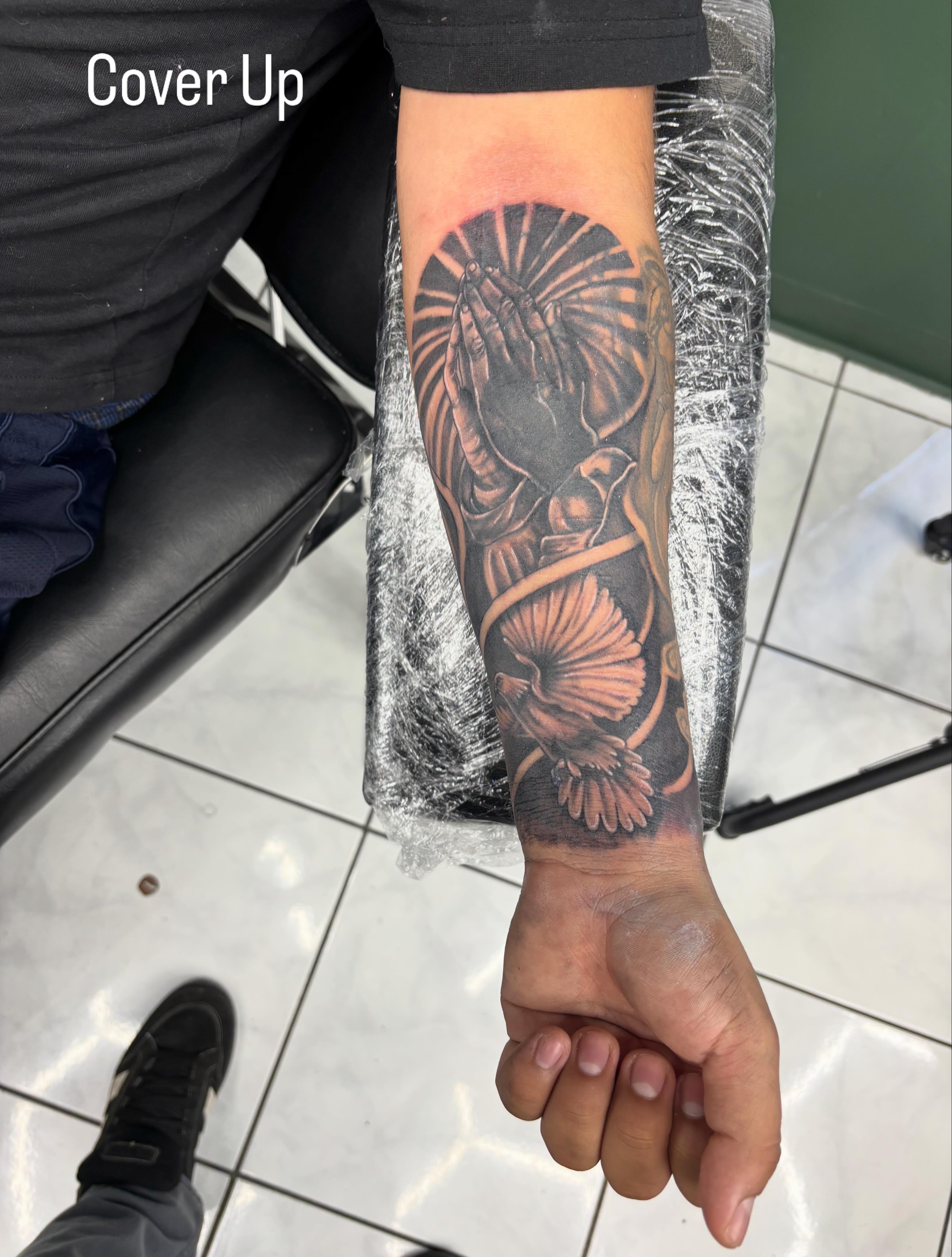 Praying hands with shells realism tattoo on the forearm by Shadows Tattoos