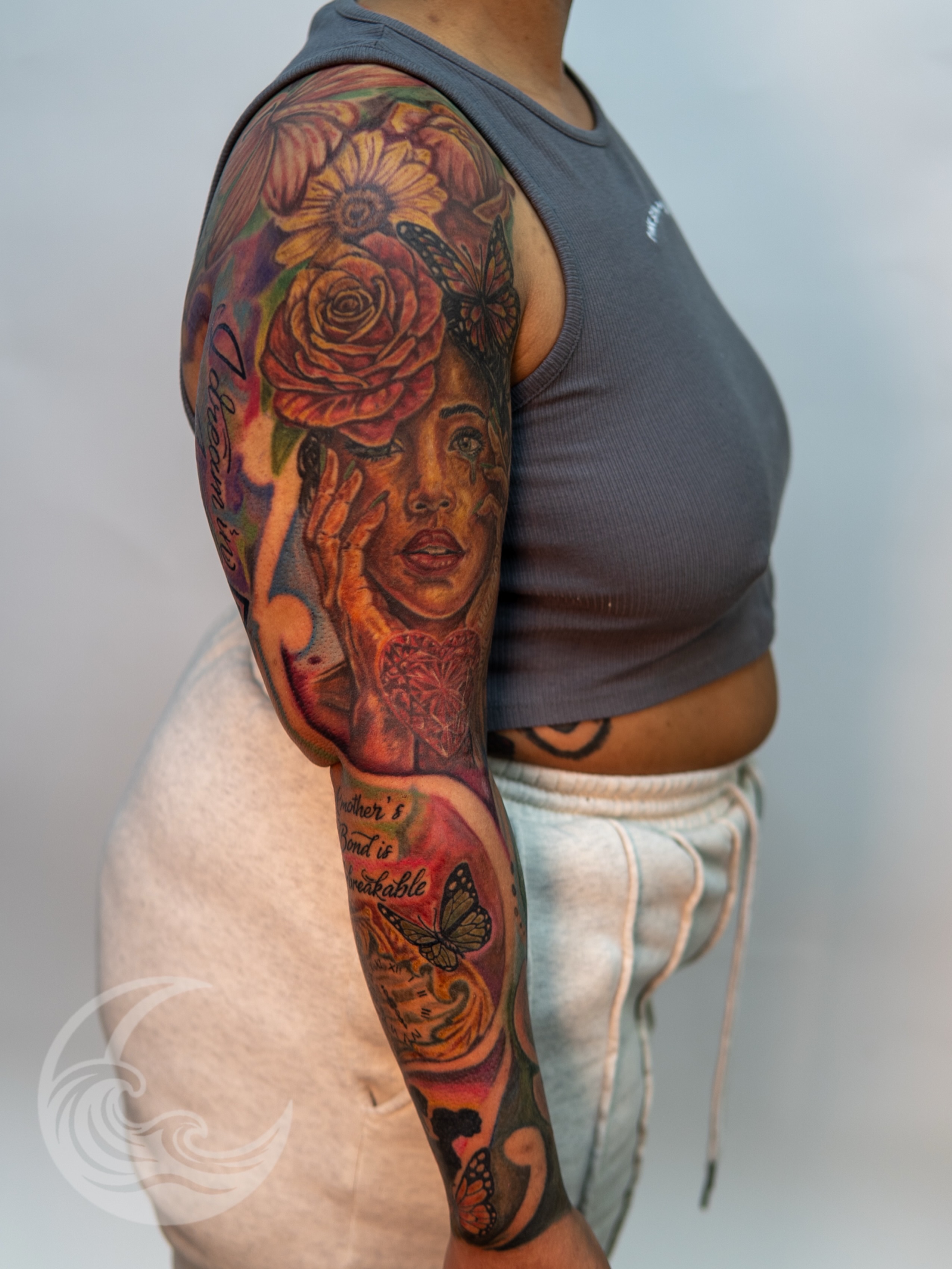 Portrait with flowers realism tattoo on the upper arm by Justin custard Tattoo💉Artist 🎨Painter