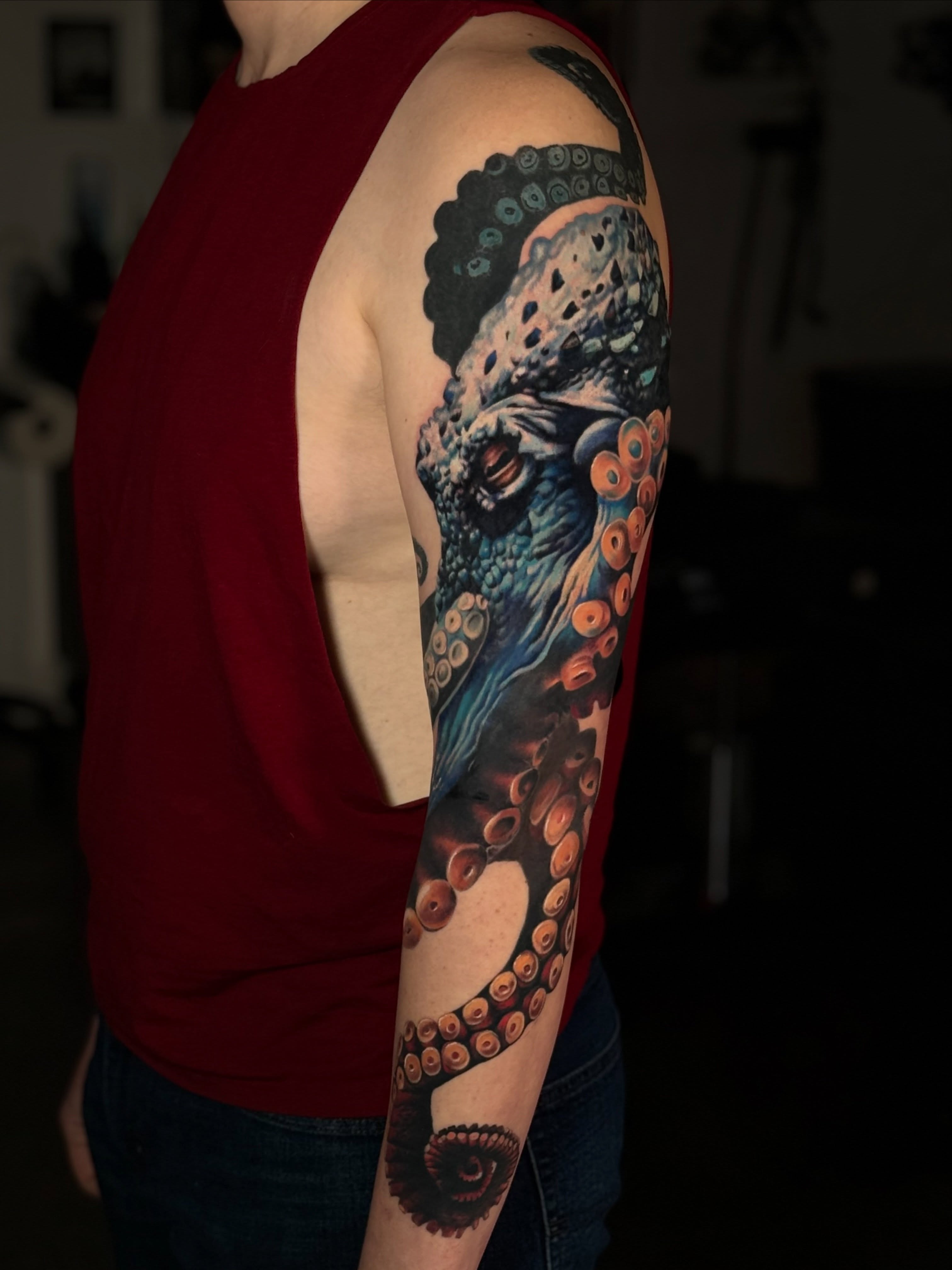 Octopus realism tattoo on the upper arm by Leah Ross