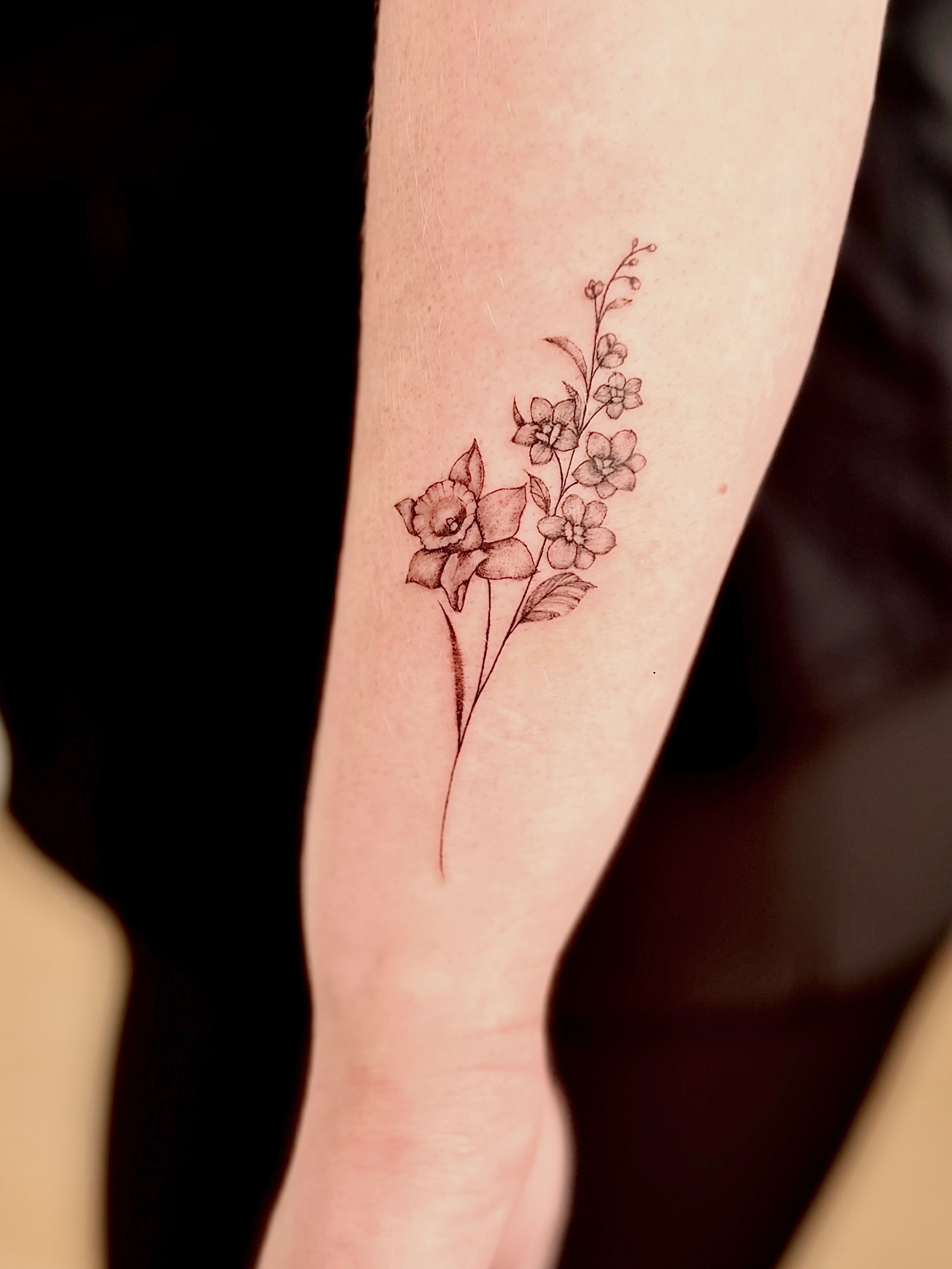 Flowers black and grey tattoo on the forearm by Fine Line Tattoo Artist