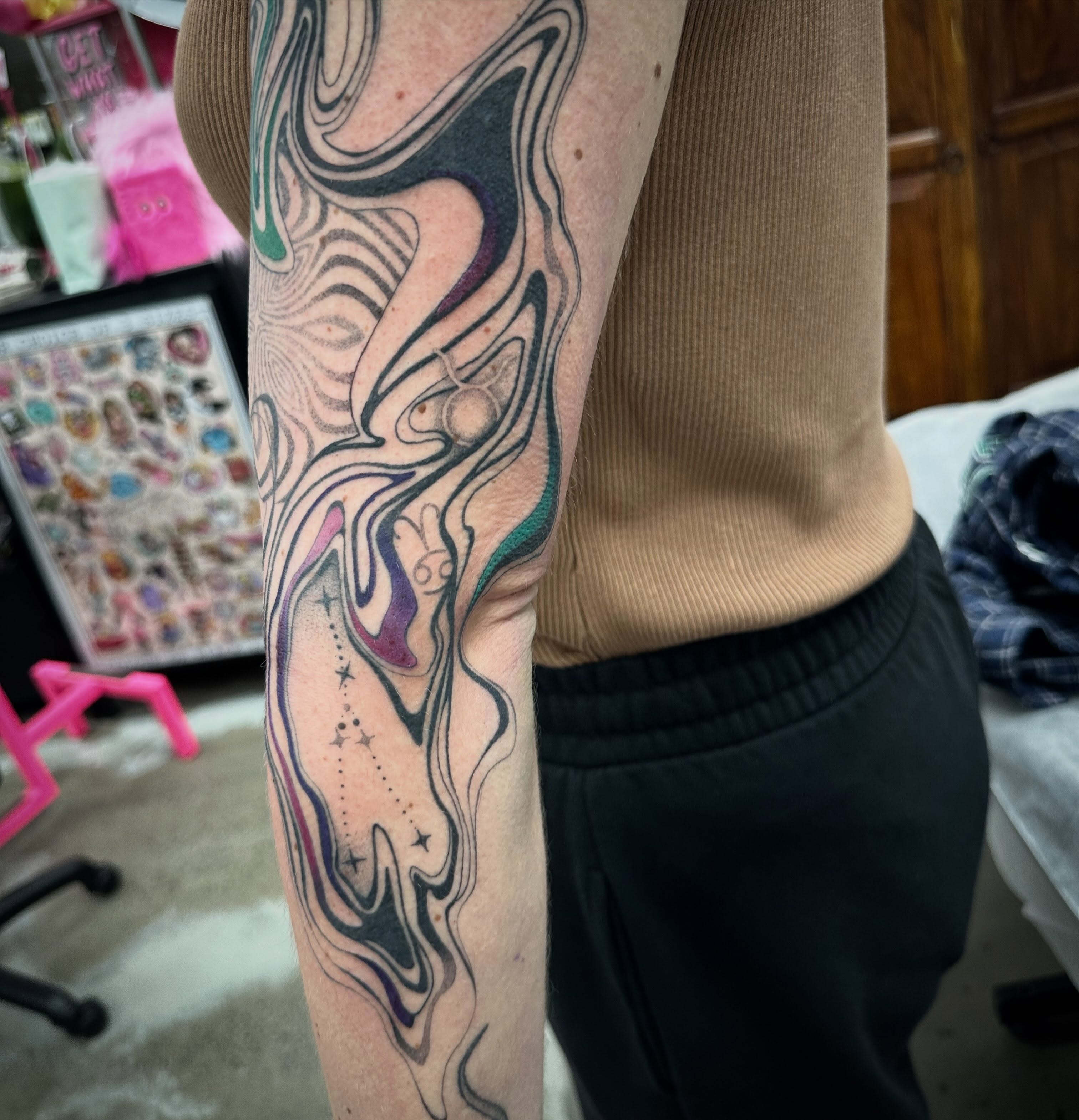 Abstract fluid design tattoo on the forearm by Lyndsay Southgate