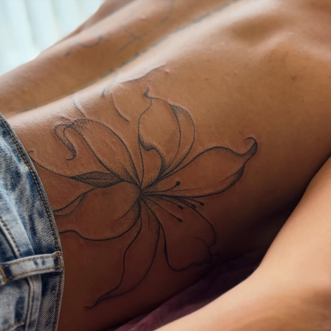 Flower black and grey tattoo on the ribs by Silva Wellen