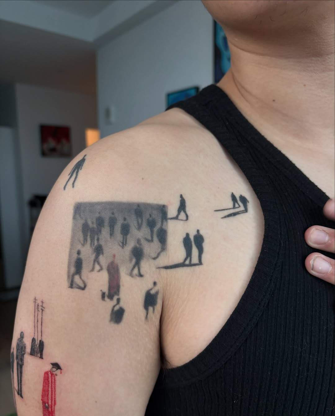 Crowd scene black and grey tattoo on the shoulder by Jinz